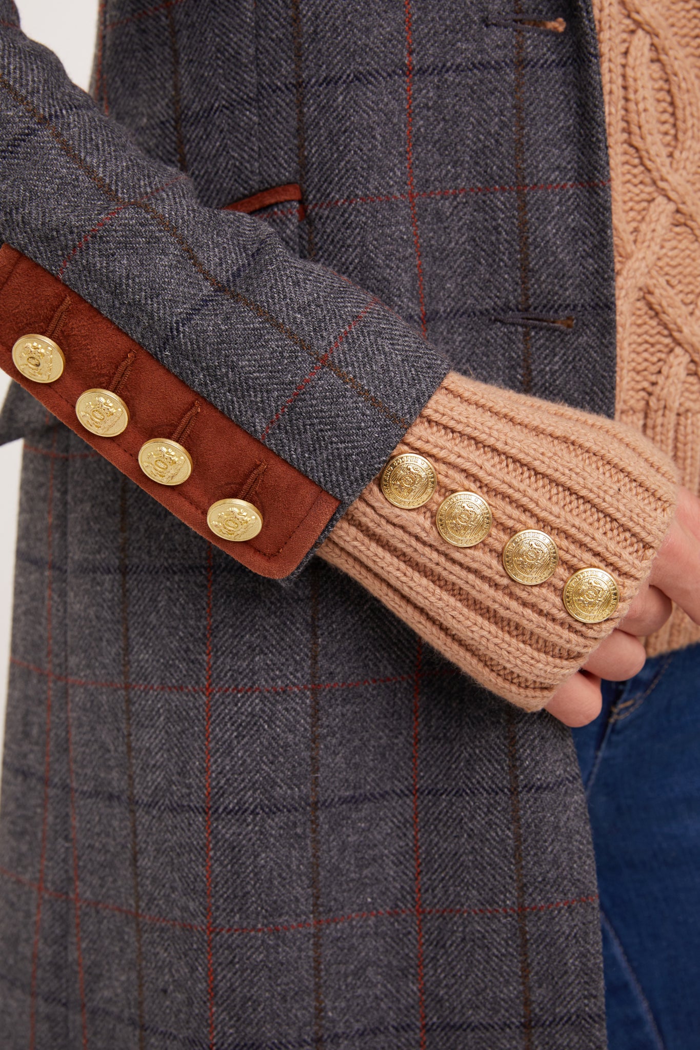 sleeve detail of grey tweed womens coat with gold hardware and tan suede detailing
