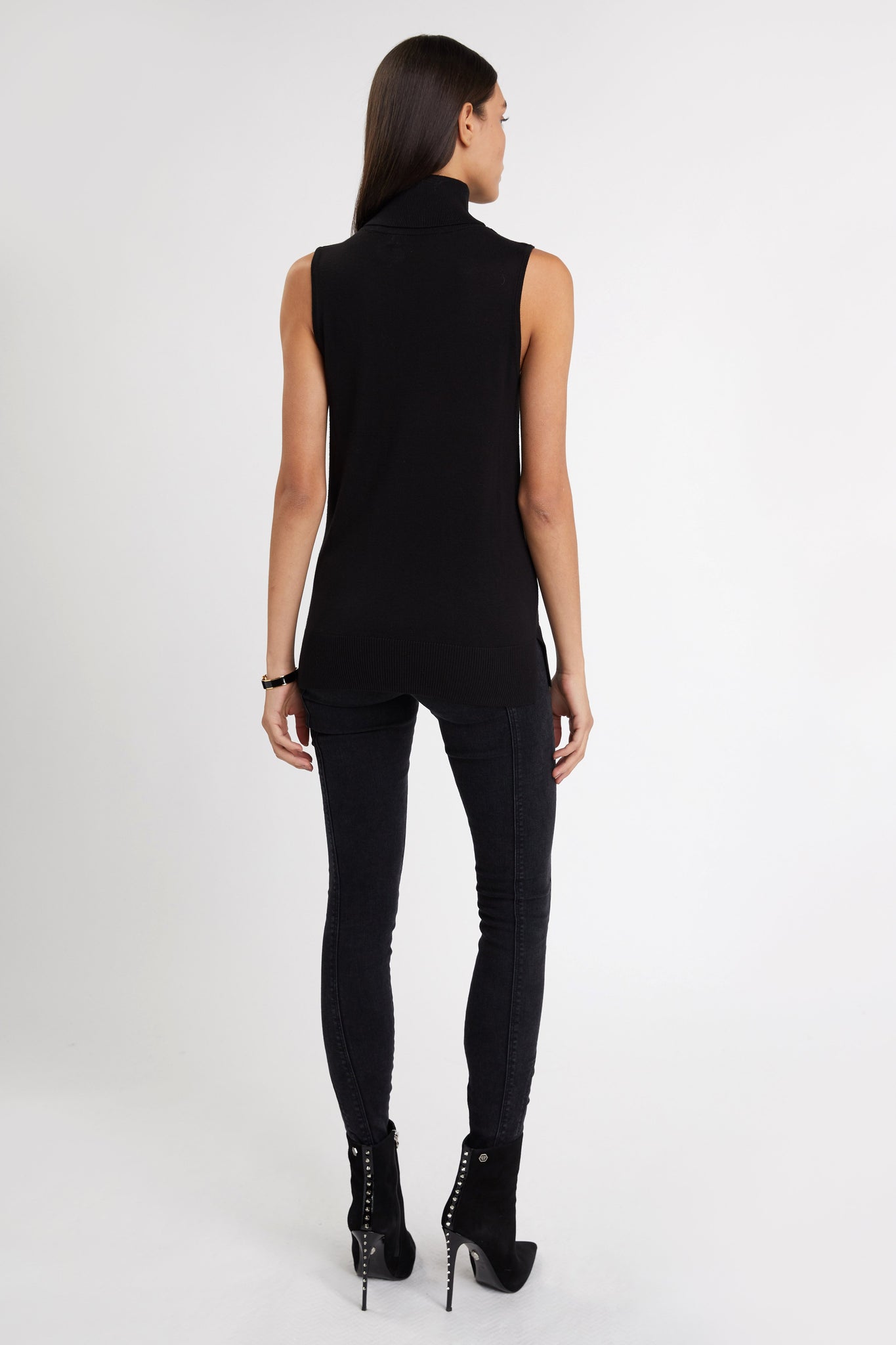back of fitted lightweight sleeveless rollneck knit in black with gold button detail across shoulders