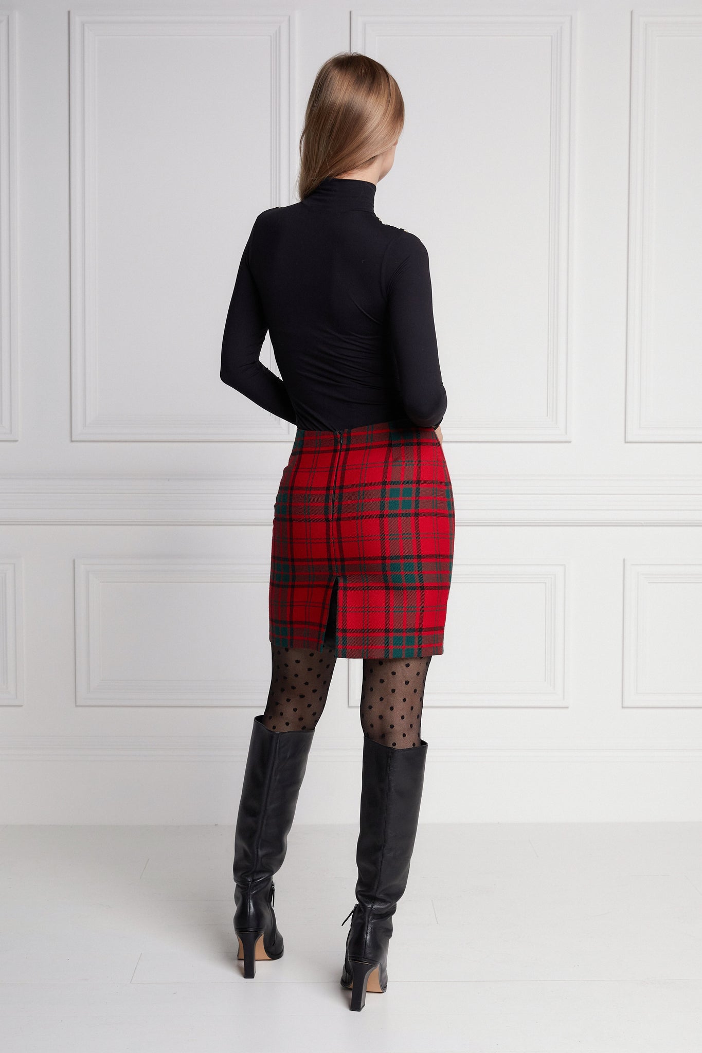 back of womens wool pencil mini skirt in red and green tartan tweed with slit on back and zip fastening on centre back
