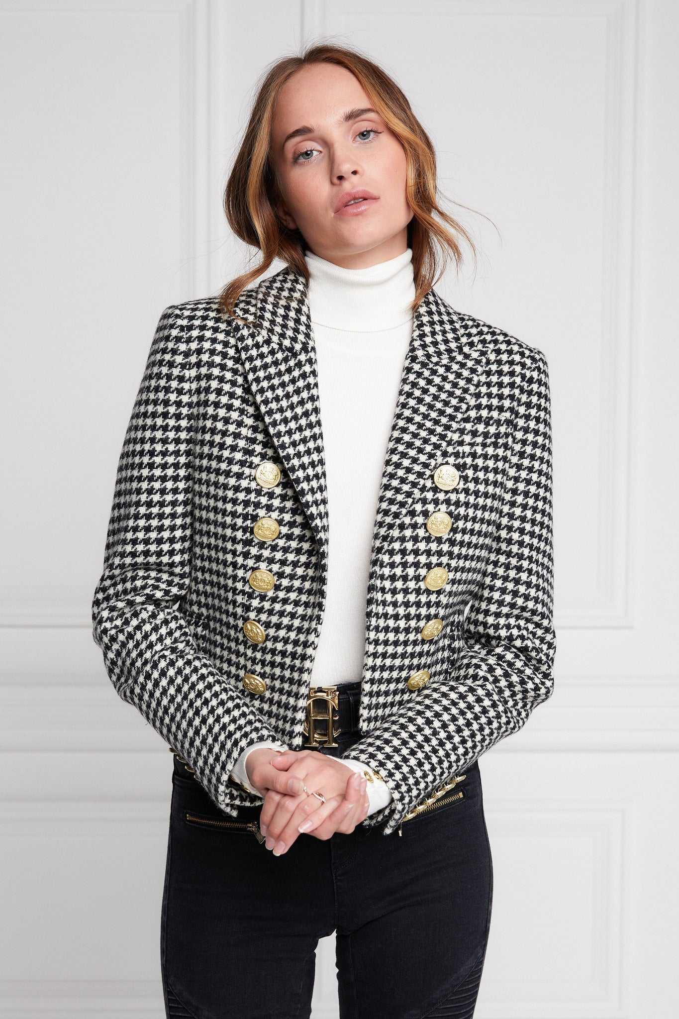 British made tailored cropped jacket in black and white houndstooth with welt pockets and gold button detail down the front and on sleeves