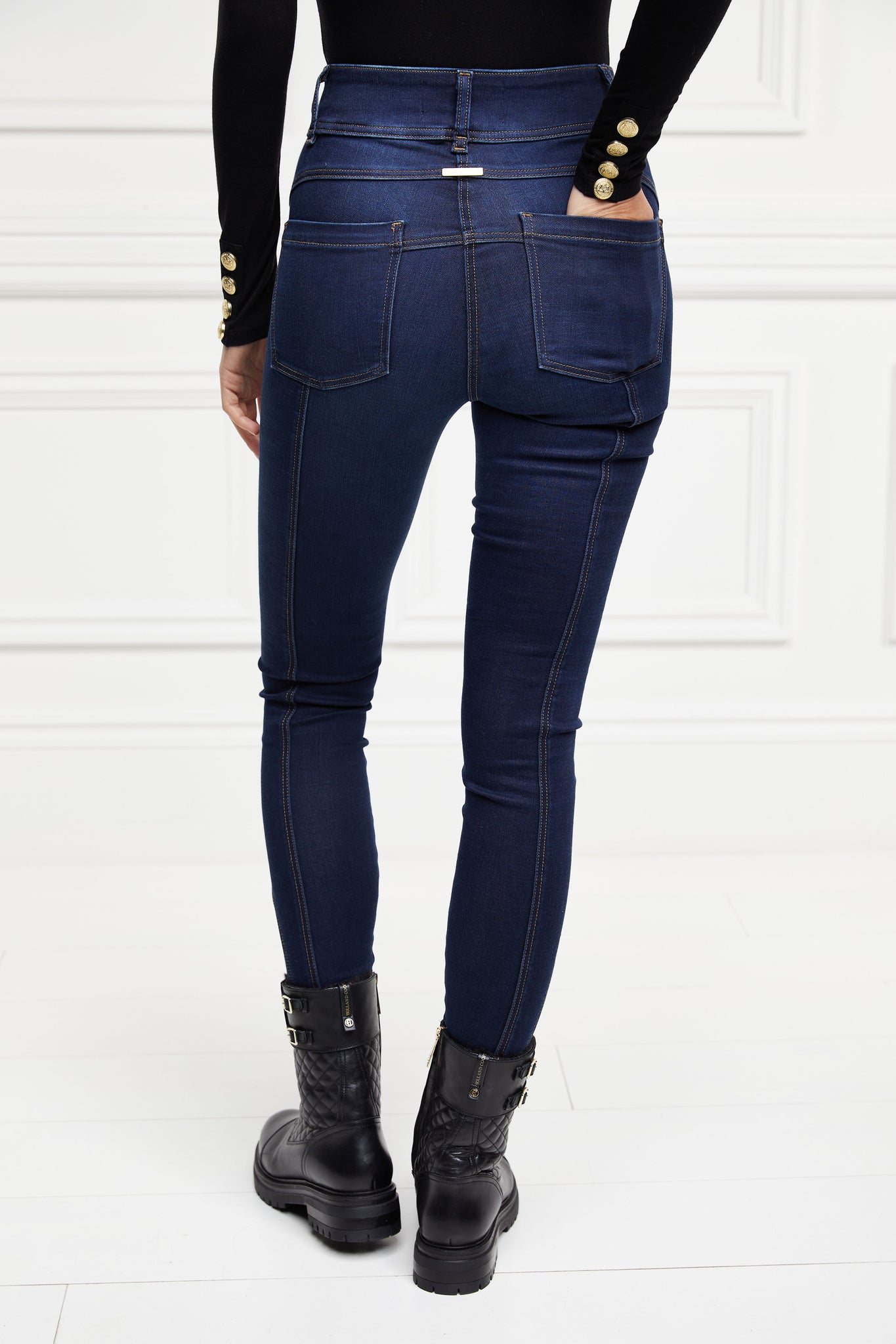 back of womens high rise dark blue denim skinny stretch thermal jean with jodhpur style seams and two open pockets to the front and back with internal fleece lining and hc gold crest on front right pocket