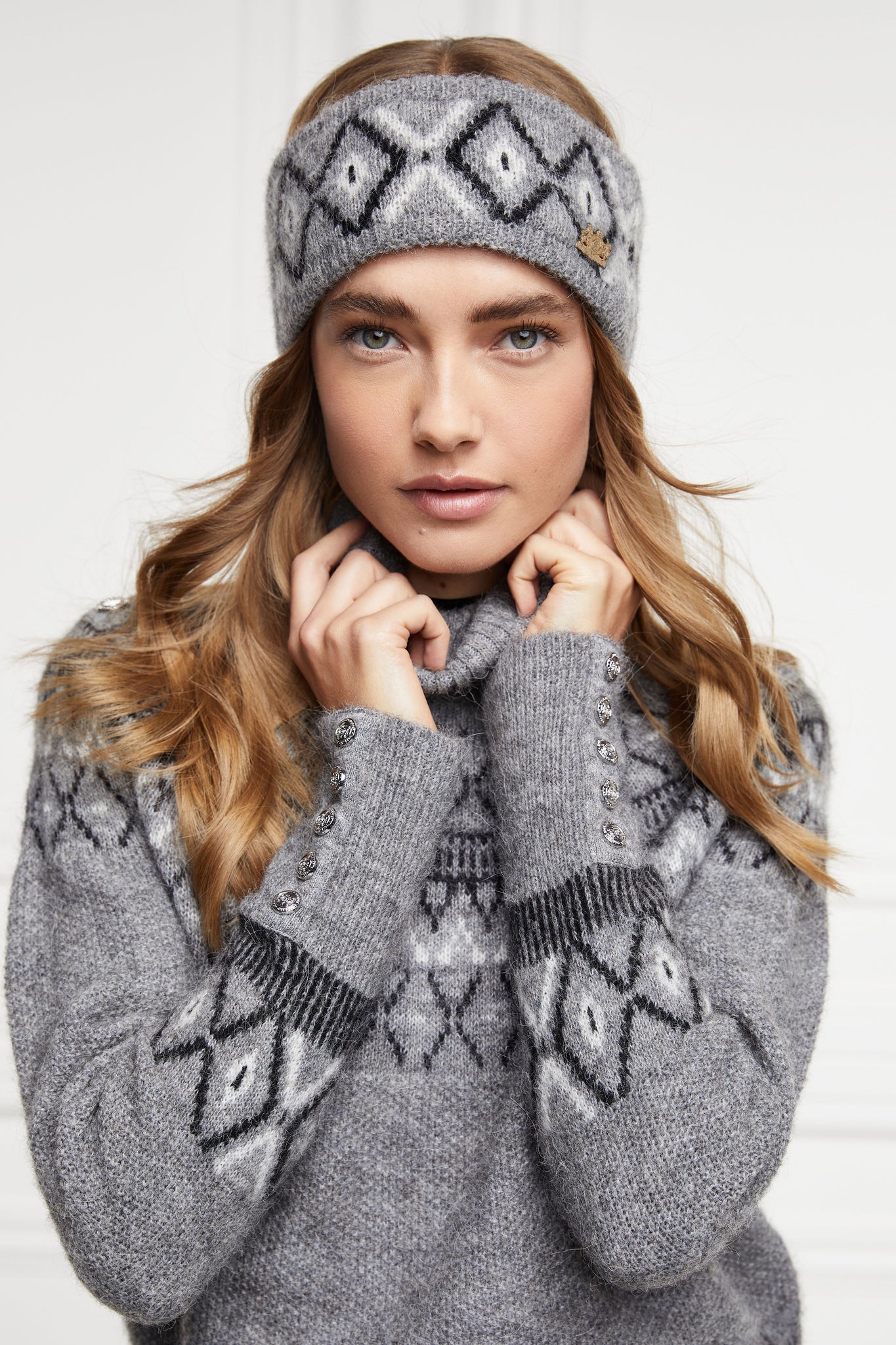 womens classic grey roll neck jumper with fairisle knit in black and white around the shoulders waistline and cuffs and a split ribbed hem with headband of the same colour and pattern