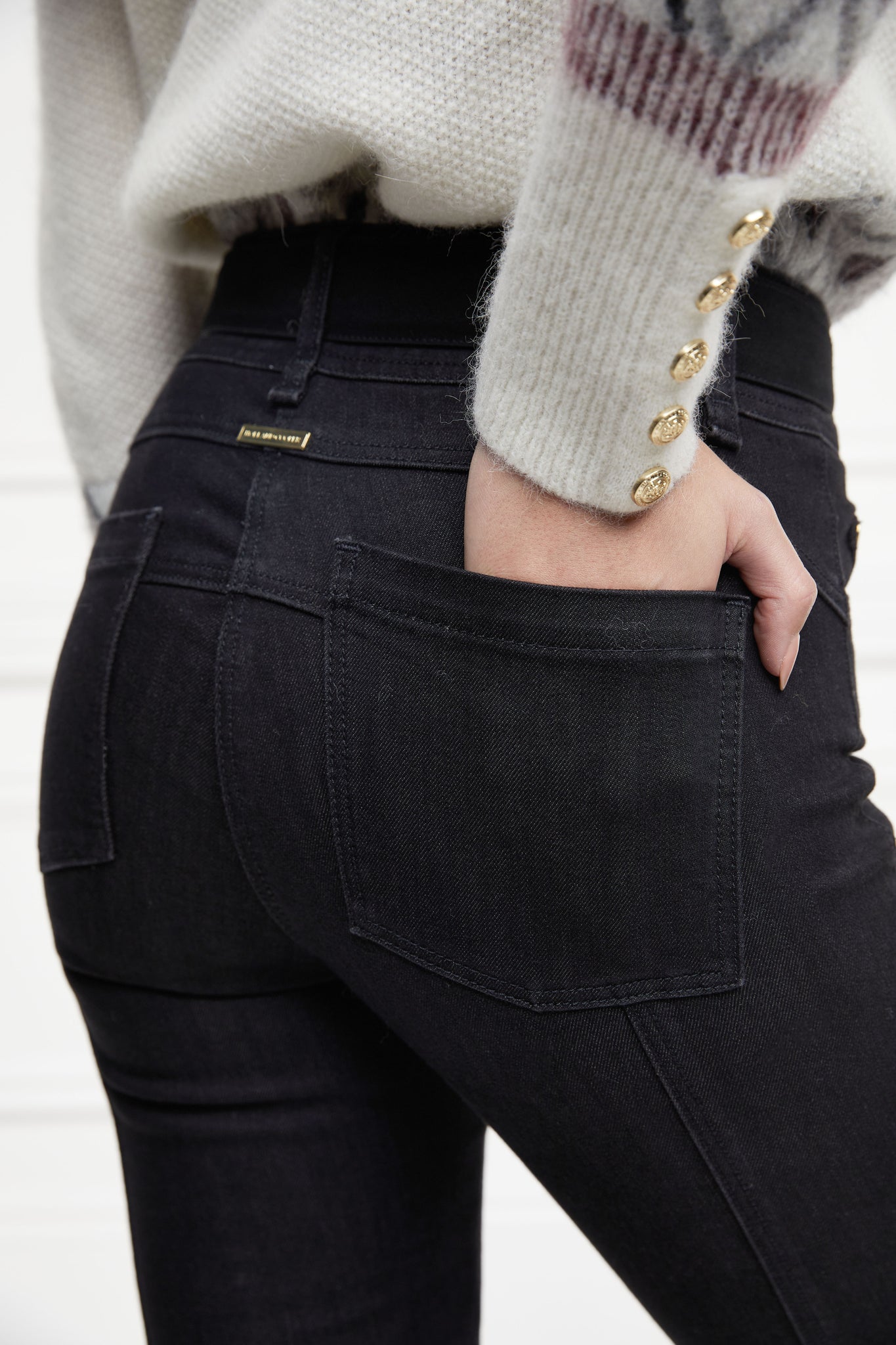 back pocket detail on womens high rise black denim skinny stretch thermal jean with jodhpur style seams and two open pockets to the front and back with internal fleece lining and hc gold crest on front right pocket
