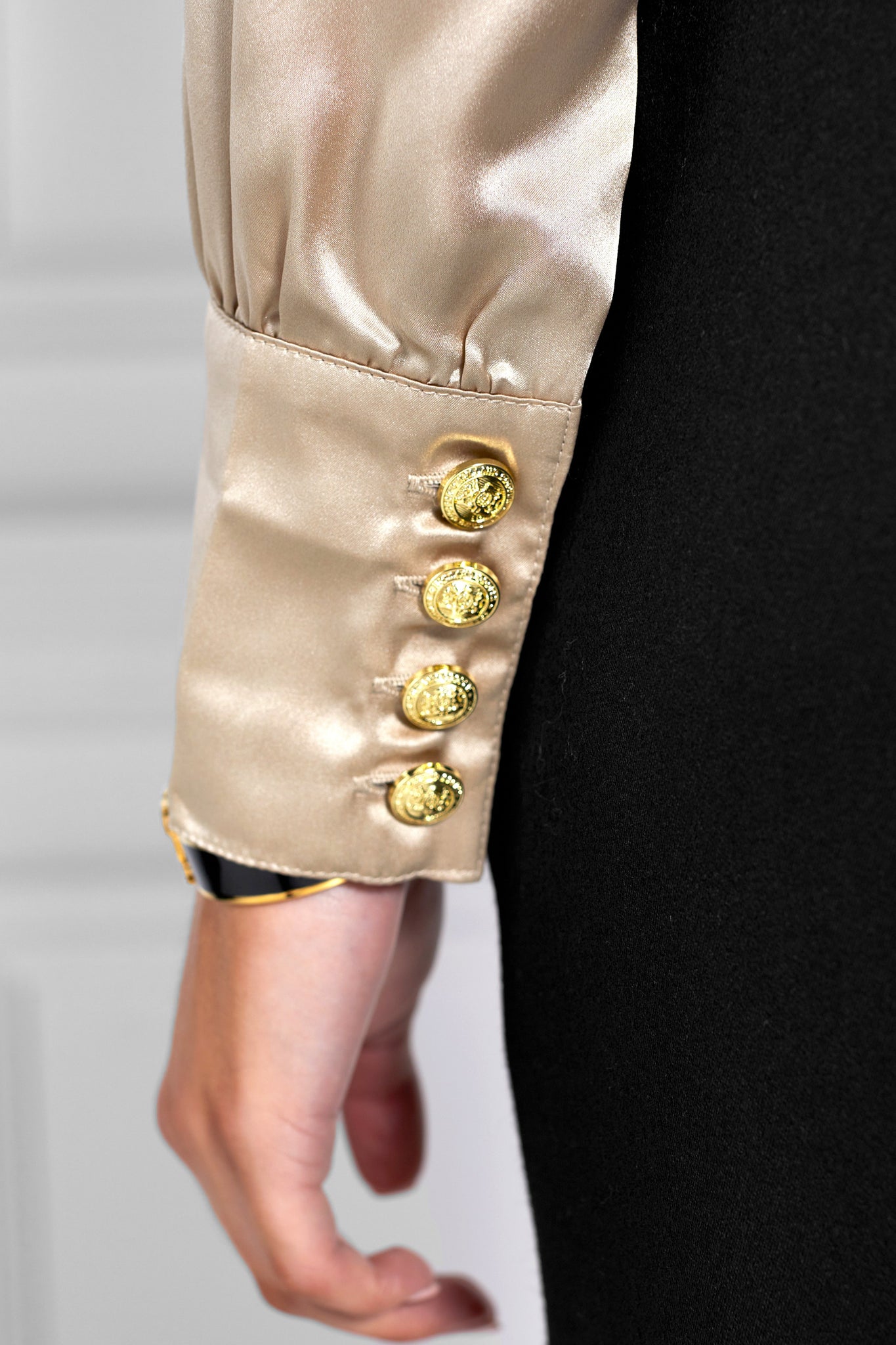 button detail on womens long sleeve silk champagne wrap front bodysuit with gold buttons