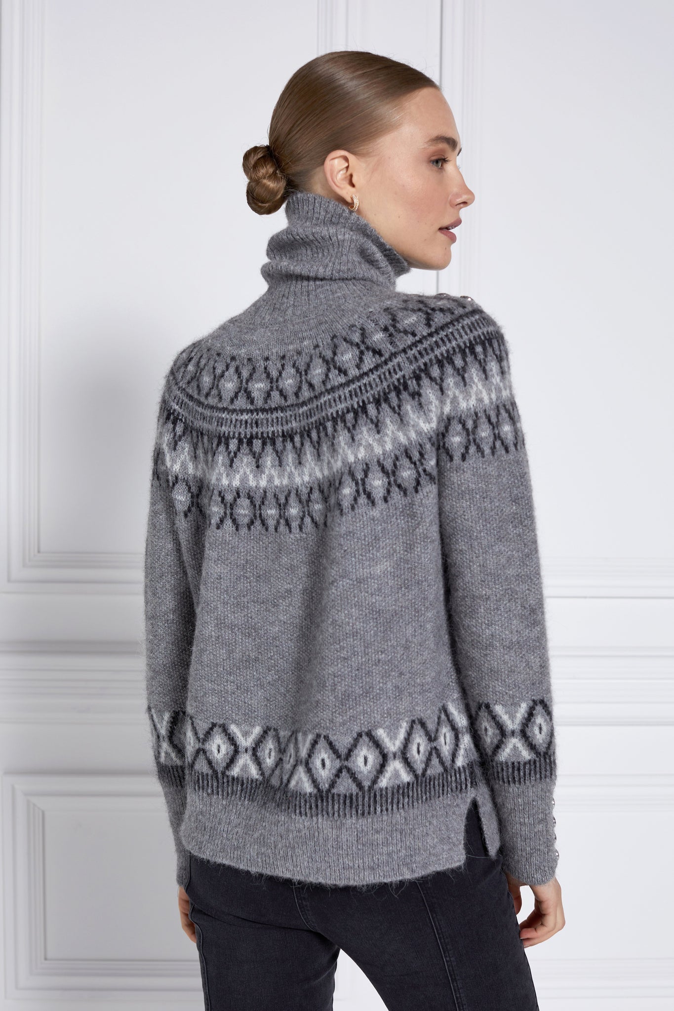 back of womens classic grey roll neck jumper with fairisle knit in black and white around the shoulders waistline and cuffs and a split ribbed hem