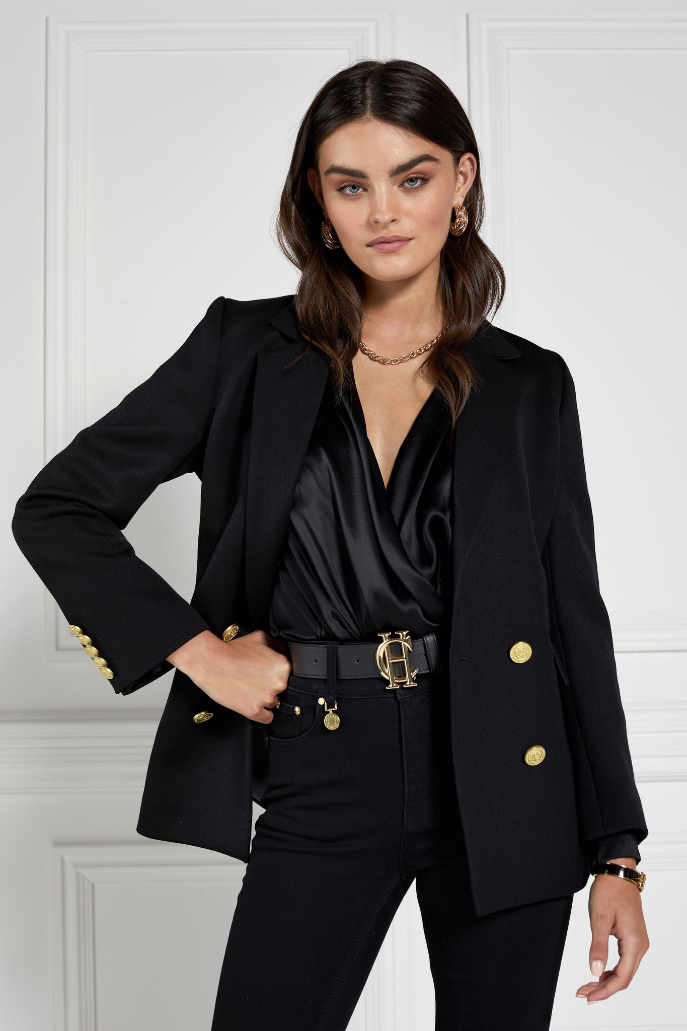 double breasted wool blazer in black with two hip pockets and gold button details down front and on cuffs and handmade in the uk