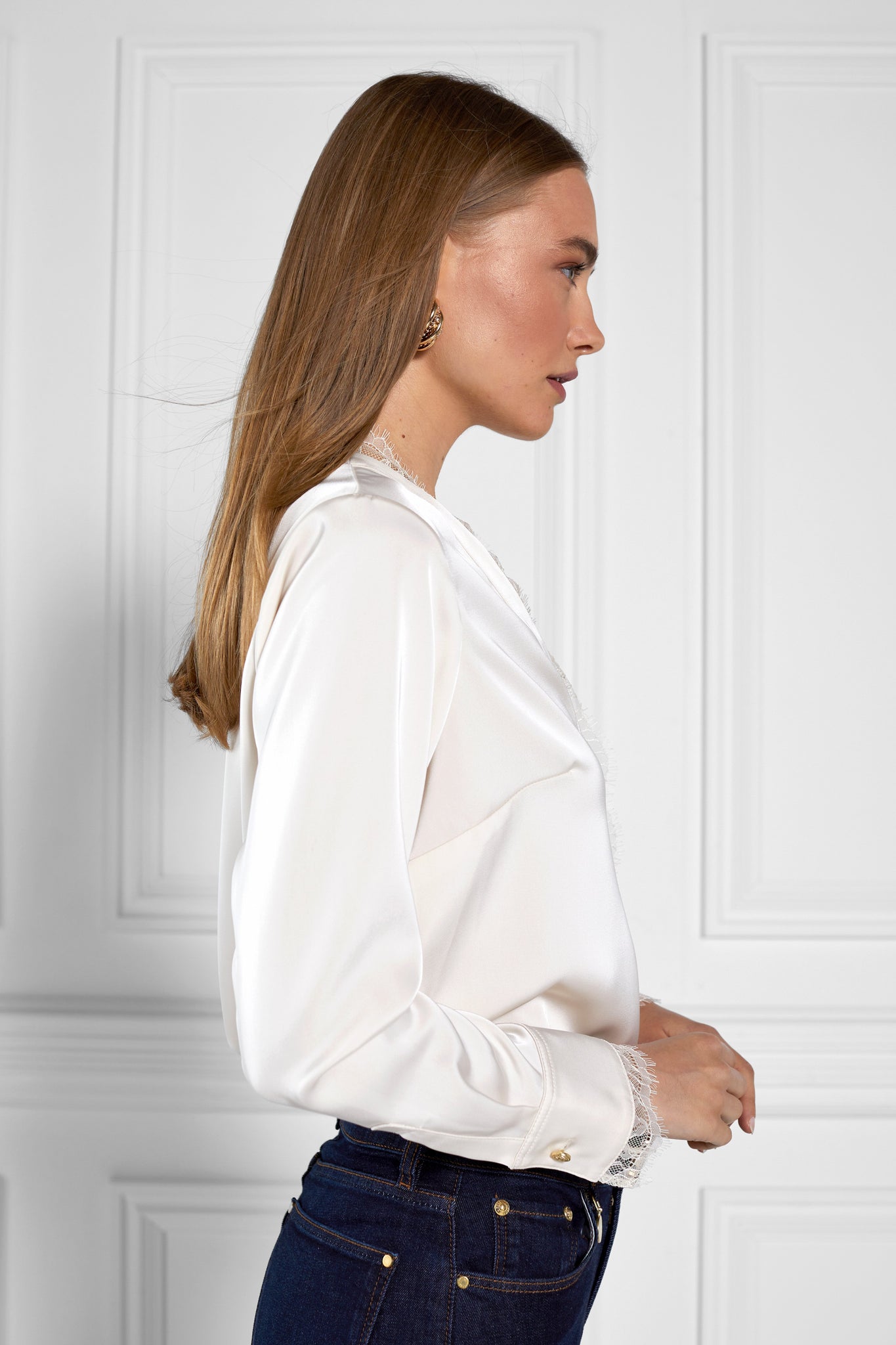 side of womens white long sleeve silk v neck blouse with white lace hem details