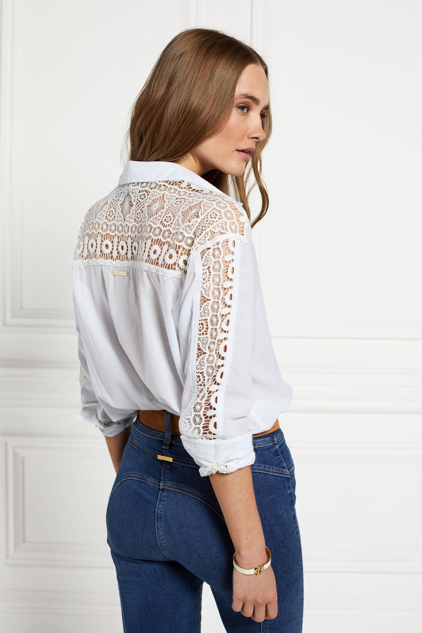 back image of relaxed shirt with pale blue and white stripes with lace panel insert across the back yolk and down the sleeves