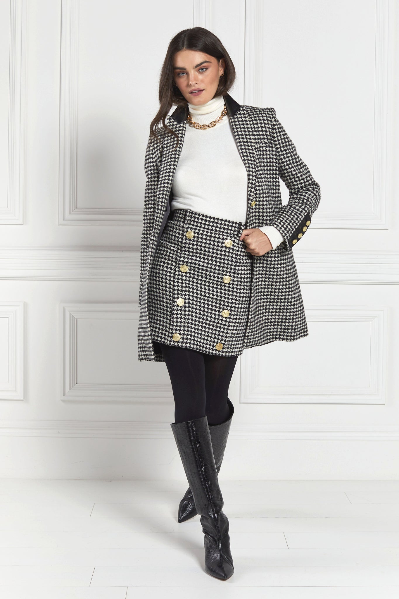 white and black houndstooth tweed womens coat with gold hardware and black leather detailing