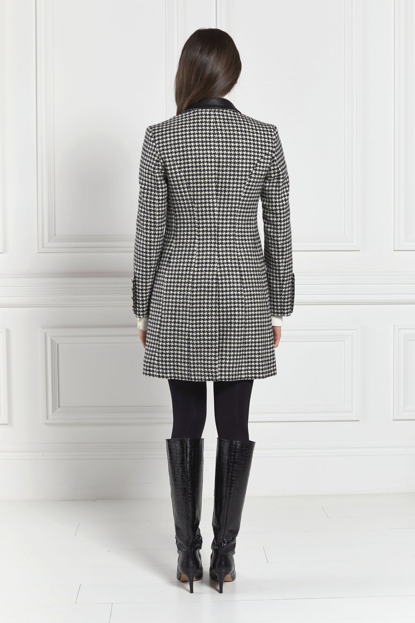back of white and black houndstooth tweed womens coat with gold hardware and black leather detailing