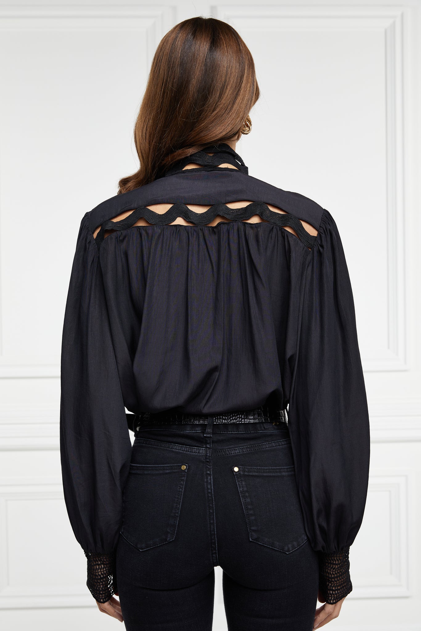 back of womens black shirt with lace detail to the collar shoulders and arm cuffs and balloon sleeve