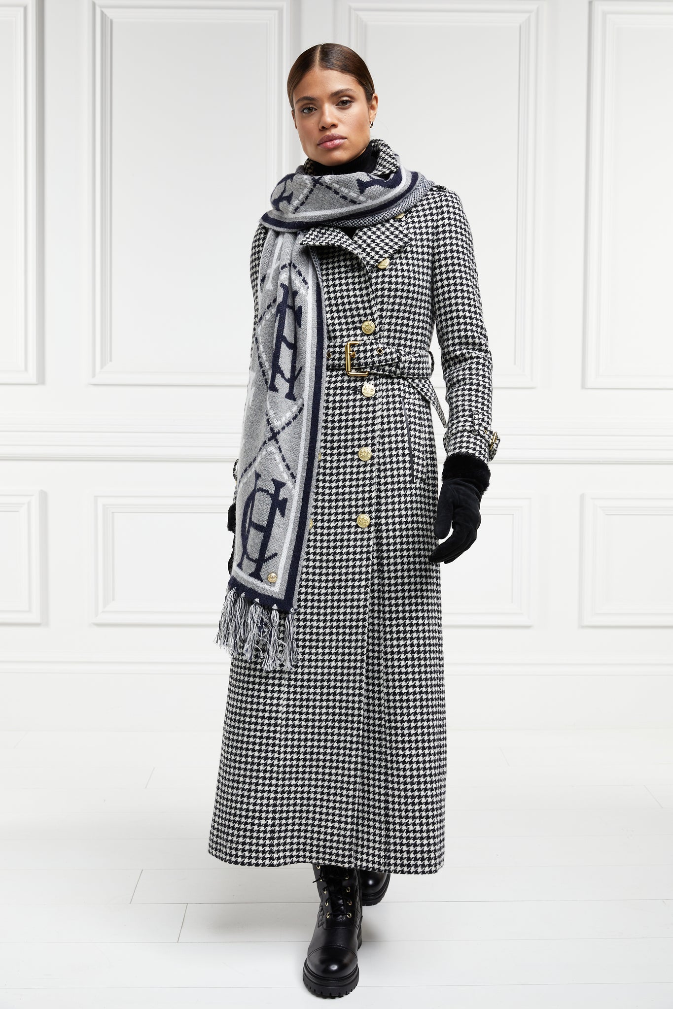 womens black and white houndstooth double breasted full length wool trench coat with grey and navy HC logo print scarf and womens suede black gloves