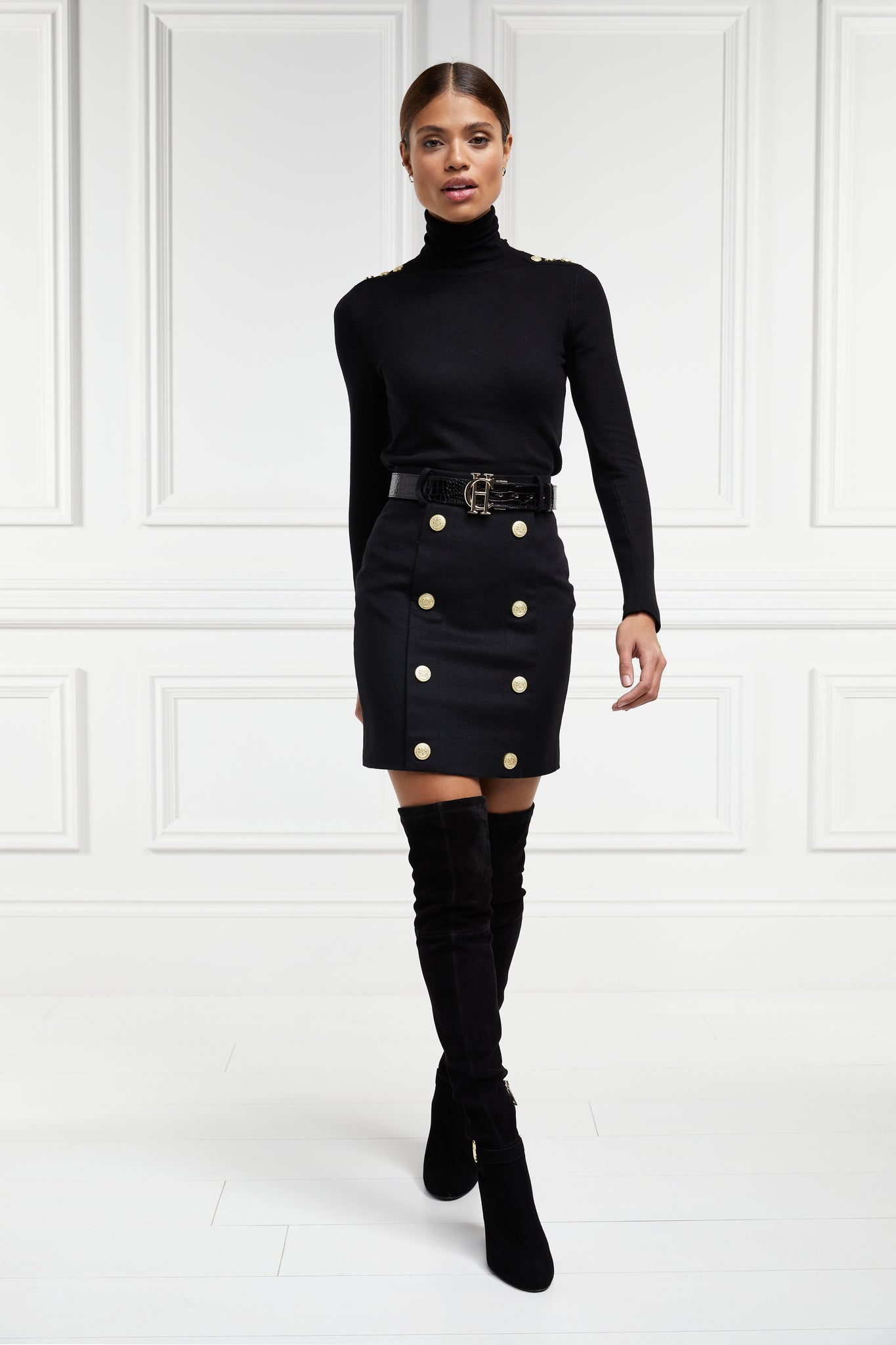 womens black wool pencil mini skirt with concealed zip fastening on centre back and gold rivets down front