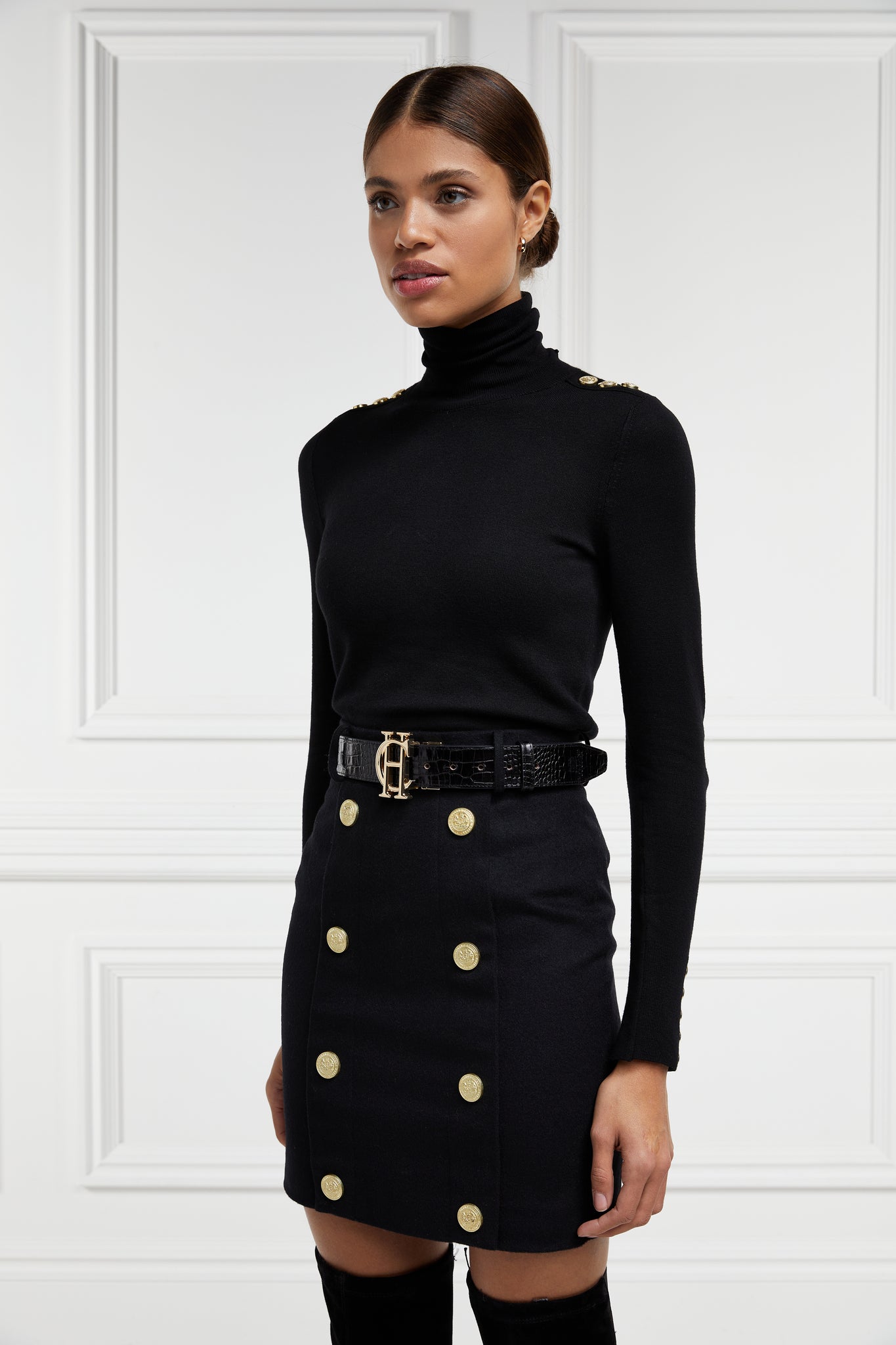 womens black wool pencil mini skirt with concealed zip fastening on centre back and gold rivets down front
