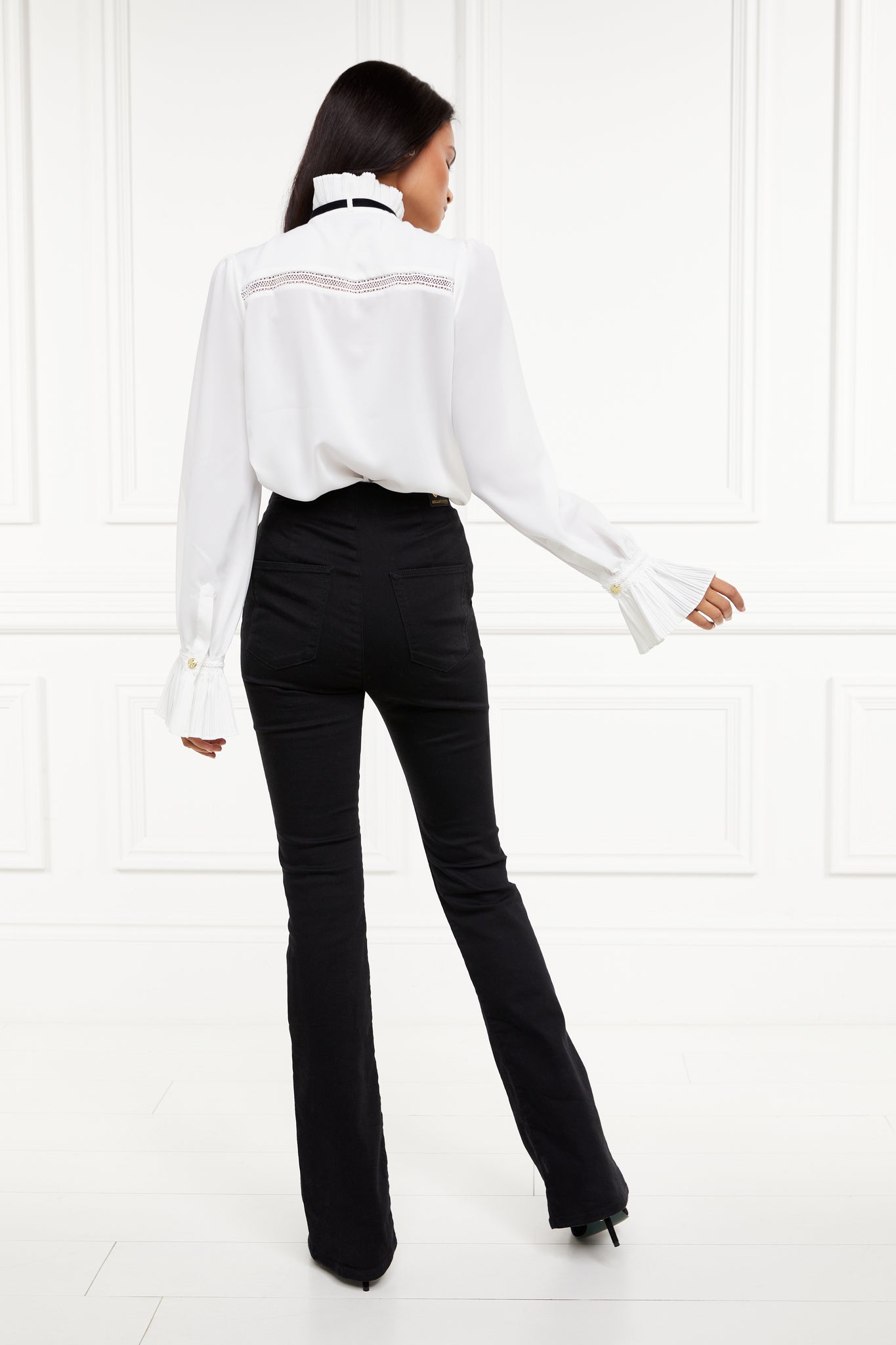 back of womens relaxed fit white polyester shirt with ruffled front collar and cuffs and removable black tie detail 