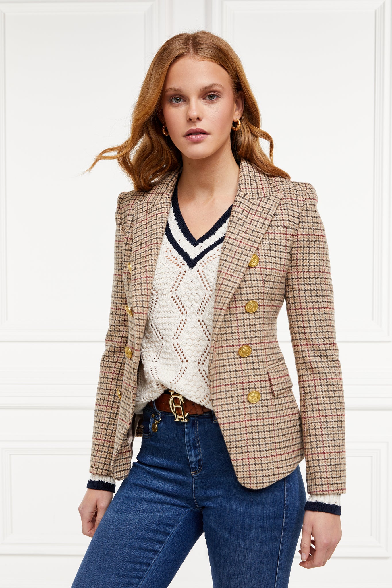 A cricket style v neck lightweight knit in cream with thick ribbed navy double stripe trims on cuffs and neckline worn with a double breasted blazer in charleton tweed 