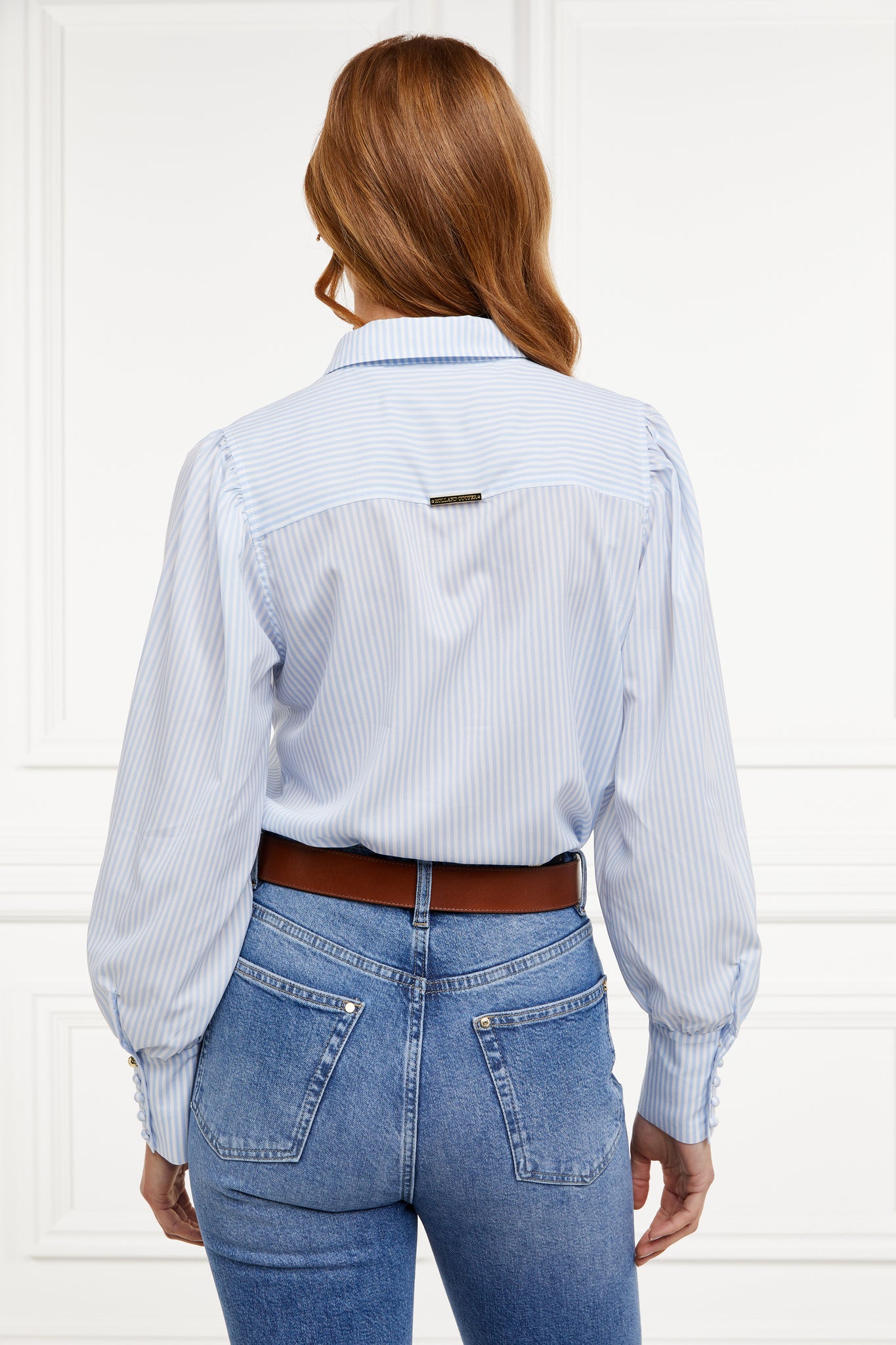 back image of A classic fitted shirt with long sleeves and subtle puffy shoulders with thin blue and white stipe print design with extra long cuffs and rounded collar detailed with fabric buttons 