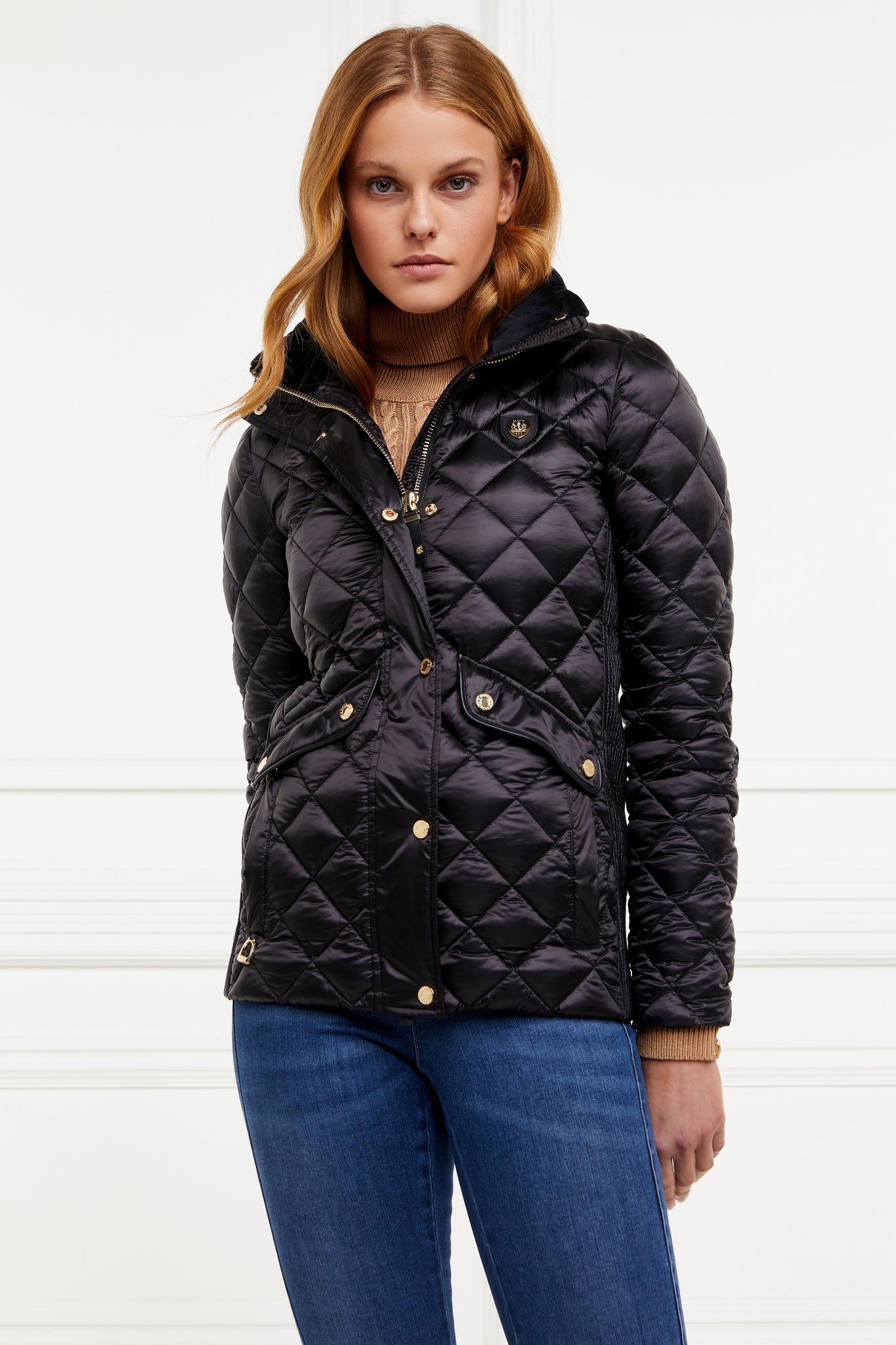 womens diamond quilted black jacket with contrast black leather elbow and shoulder pads large front pockets and shirred side panels