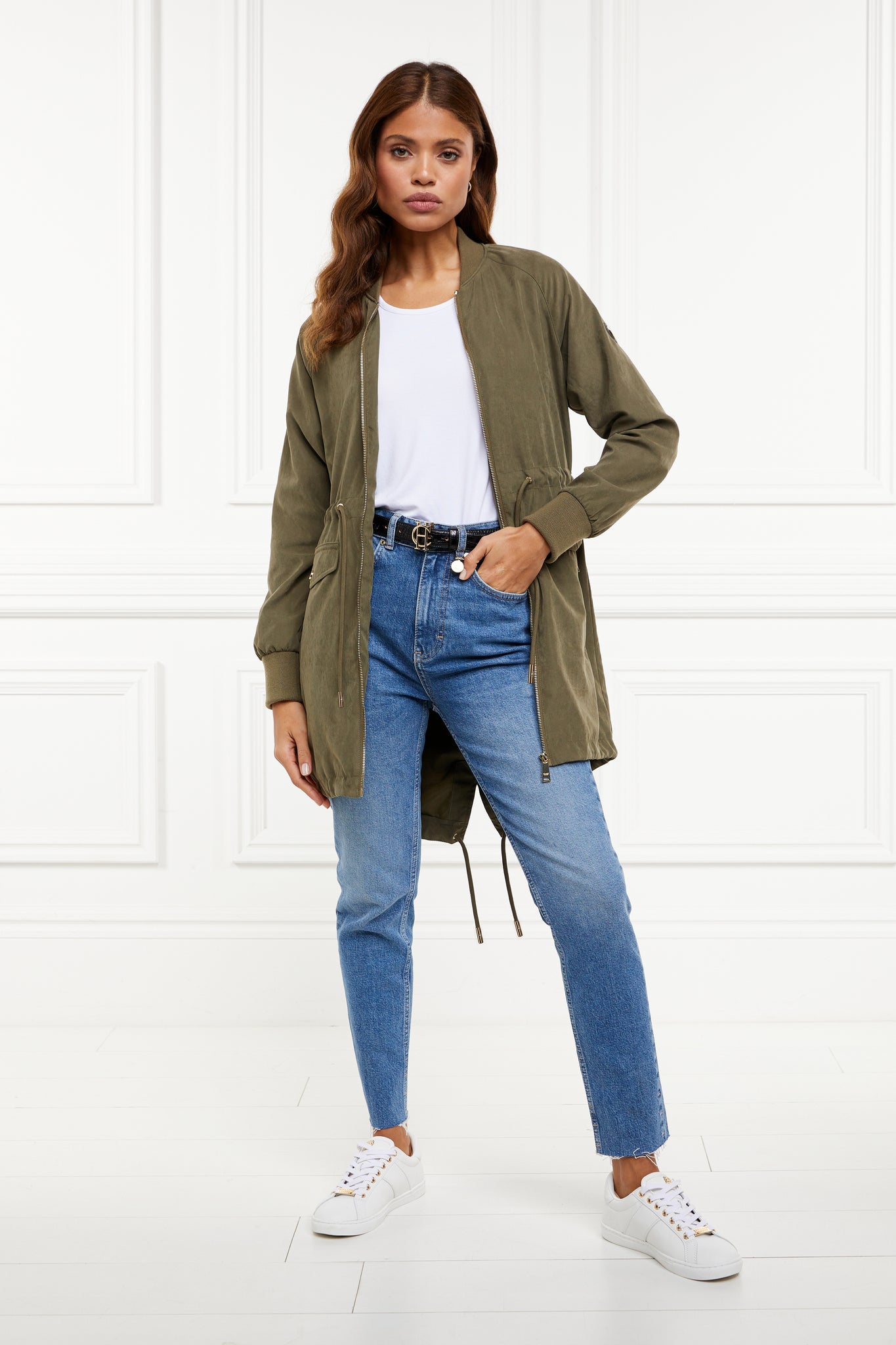  brushed suede longline lightweight parka jacket in khaki with an adjustable drawstring waist and fishtail hem and ribbed baseball style jersey collar and cuffs finished with gold hardware and gold shield on sleeve