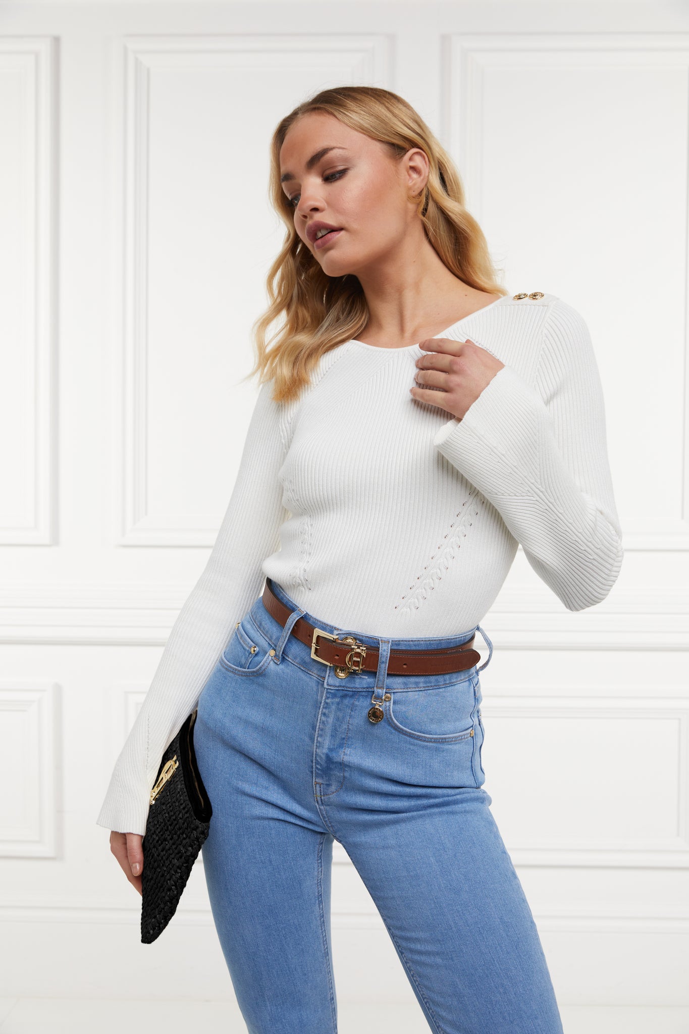 womens white ribbed long sleeve knit with denim jeans and black raffia bag