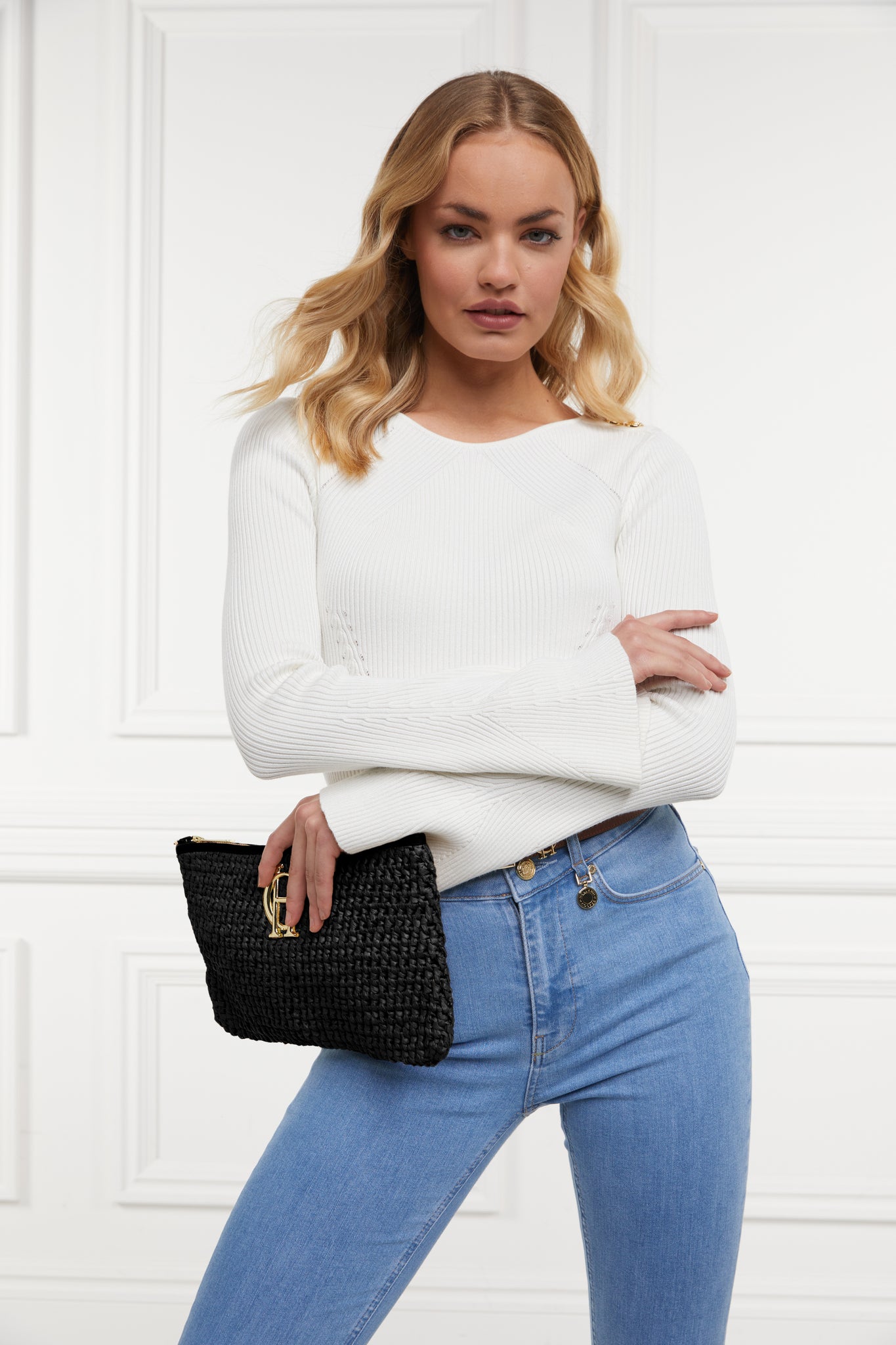 womens white ribbed long sleeve knit with denim jeans and black raffia bag