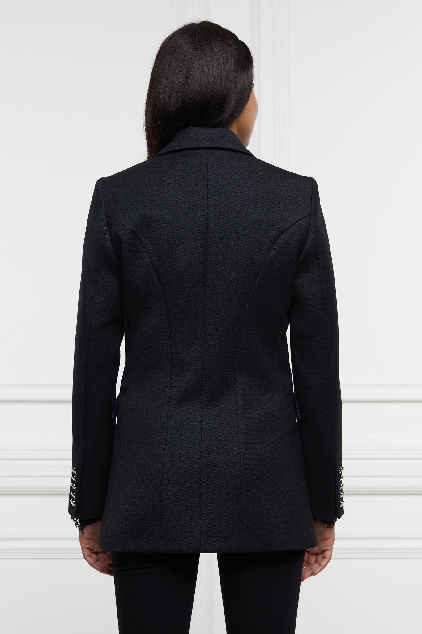 back of jubilee edition of double breasted wool blazer in black with two hip pockets and silver button details down front and on cuffs and handmade in the uk