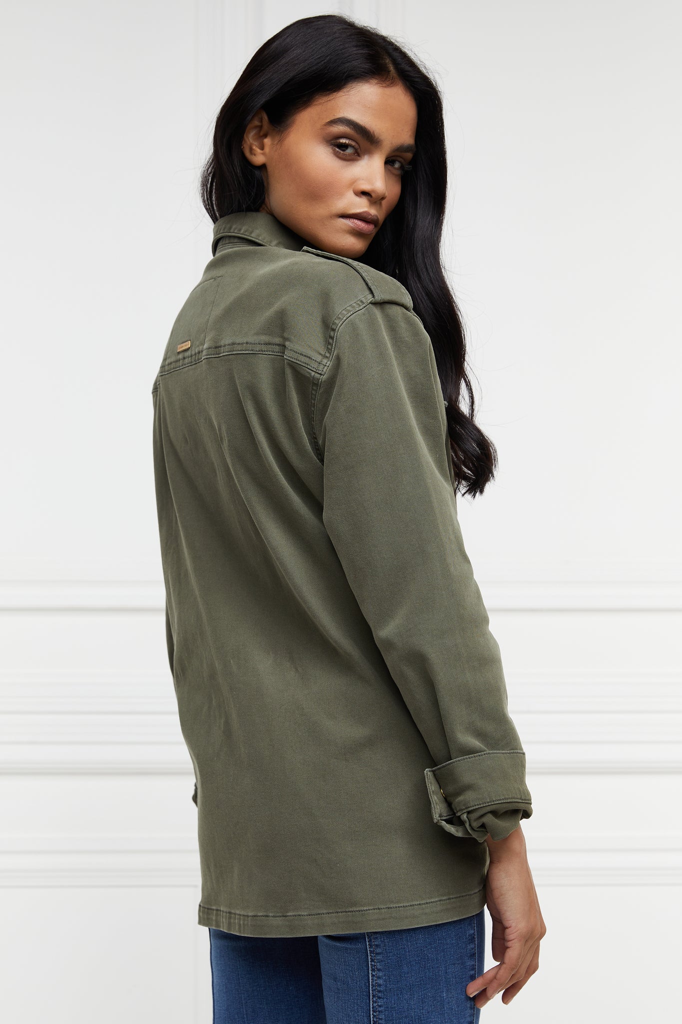 side of Relaxed fit collared artillery style jacket in khaki with four pockets two chest ones being box pleated  and two hip being patch pockets with gold jean button fastenings adjustable long sleeves and epaulette shoulder detail