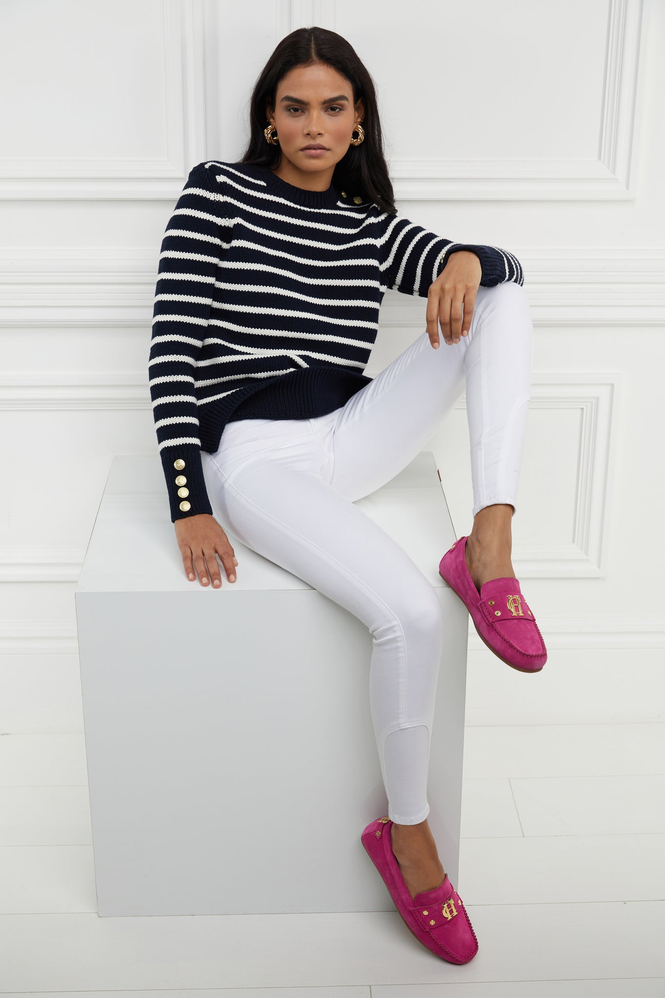 bright pink suede loafers with a leather sole and top stitching details and gold hardware paired with white skinny jeans and navy striped crew jumper