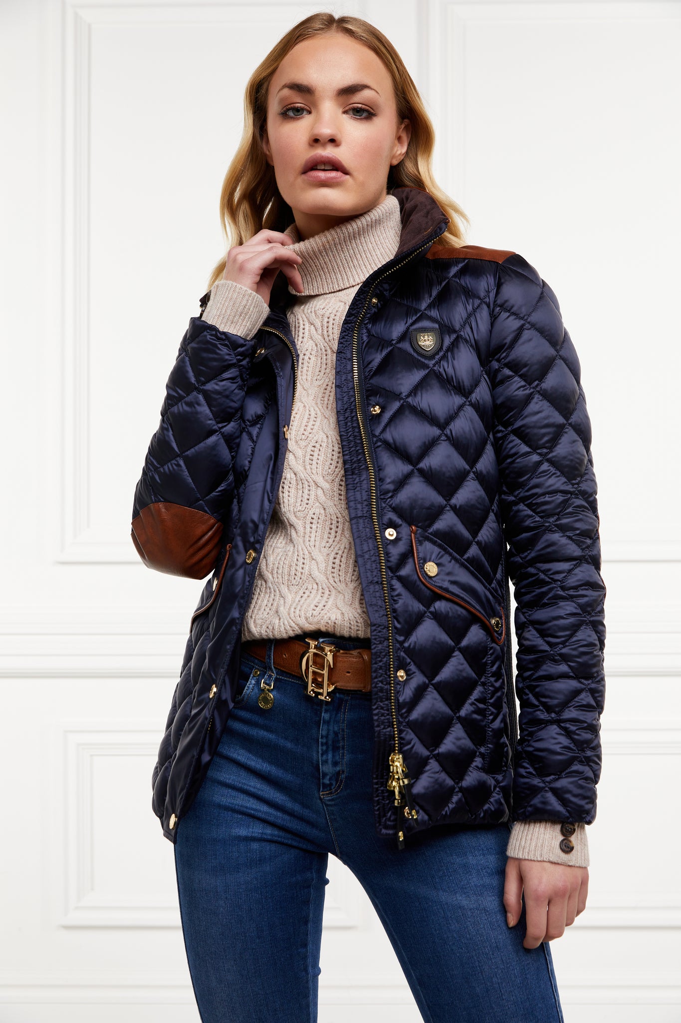 womens diamond quilted navy jacket with contrast tan leather elbow and shoulder pads large front pockets and shirred side panels