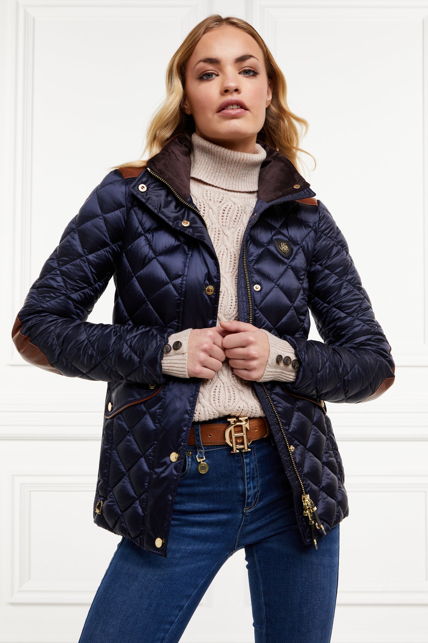 womens diamond quilted navy jacket with contrast tan leather elbow and shoulder pads large front pockets and shirred side panels