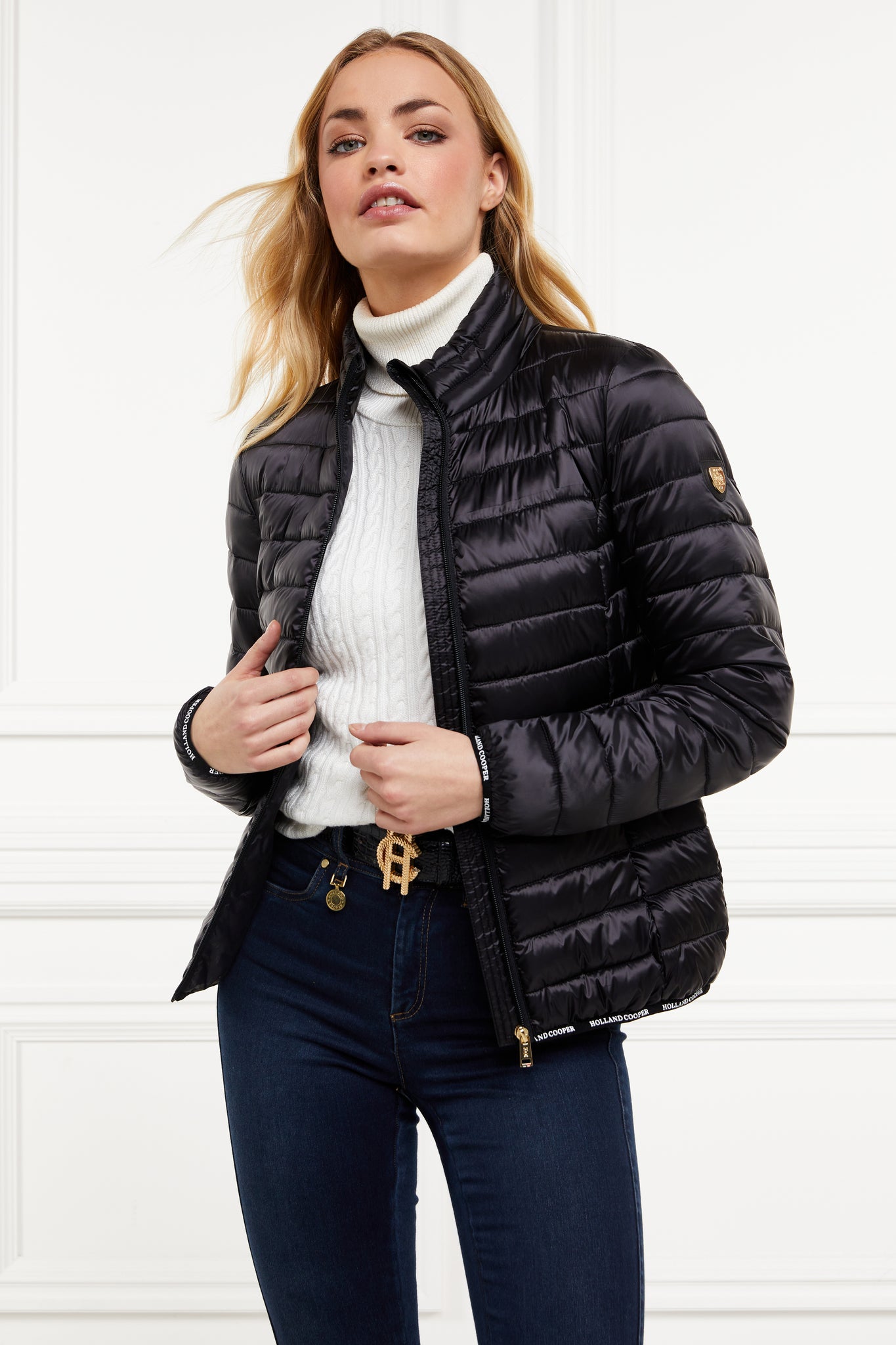 womens lightweight hoodless padded black jacket with embroidery detail on back high neck and elasticated cuffs and hem. easily packs away into separate small bag of the same colour with handle 