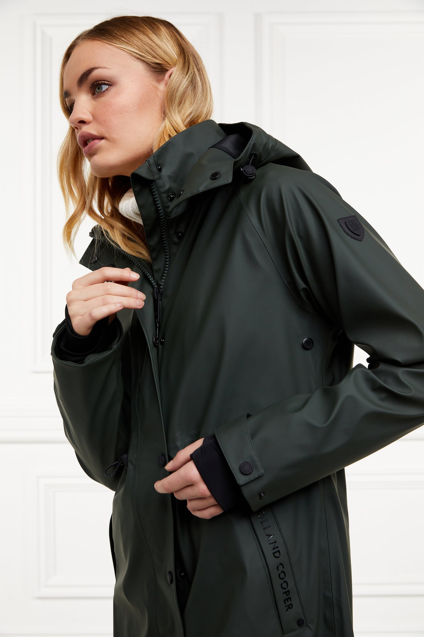 womens green hooded rain coat with black hardware 