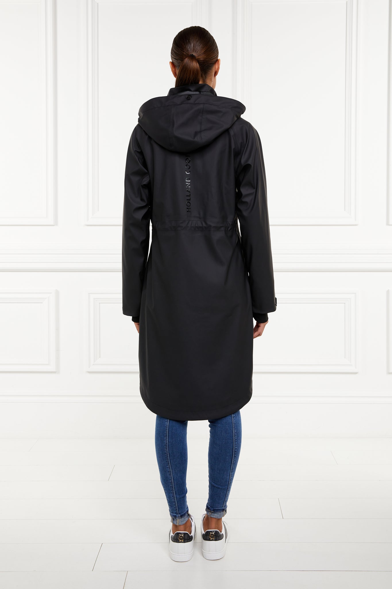back of womens black hooded rain coat with black hardware 