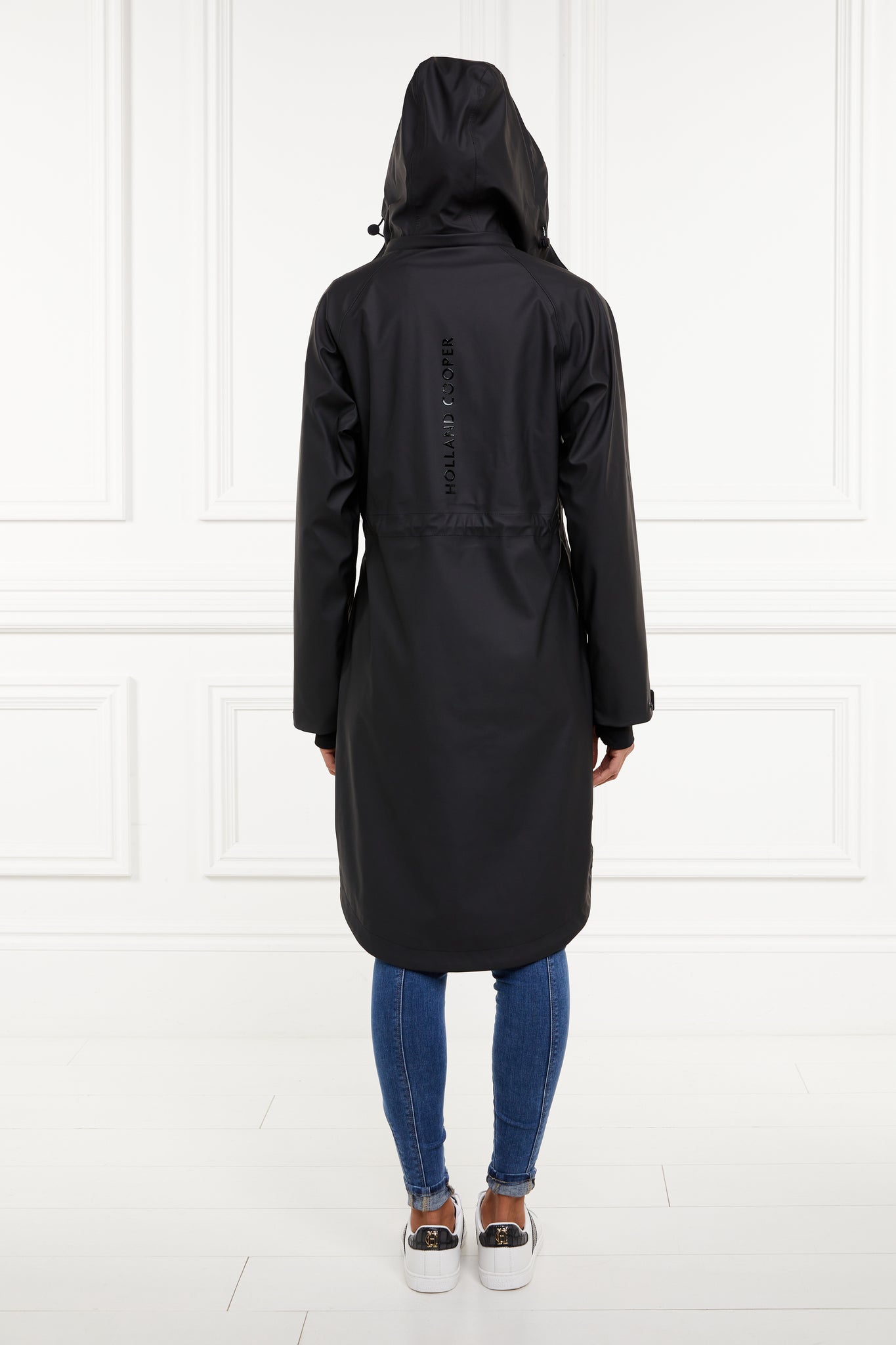 back of womens black hooded rain coat with black hardware 