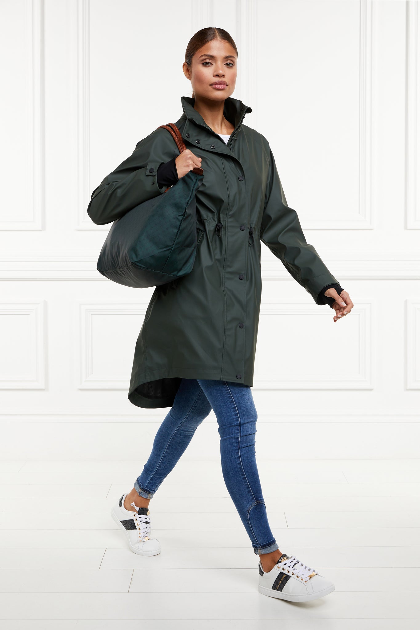 womens green hooded rain coat with black hardware 