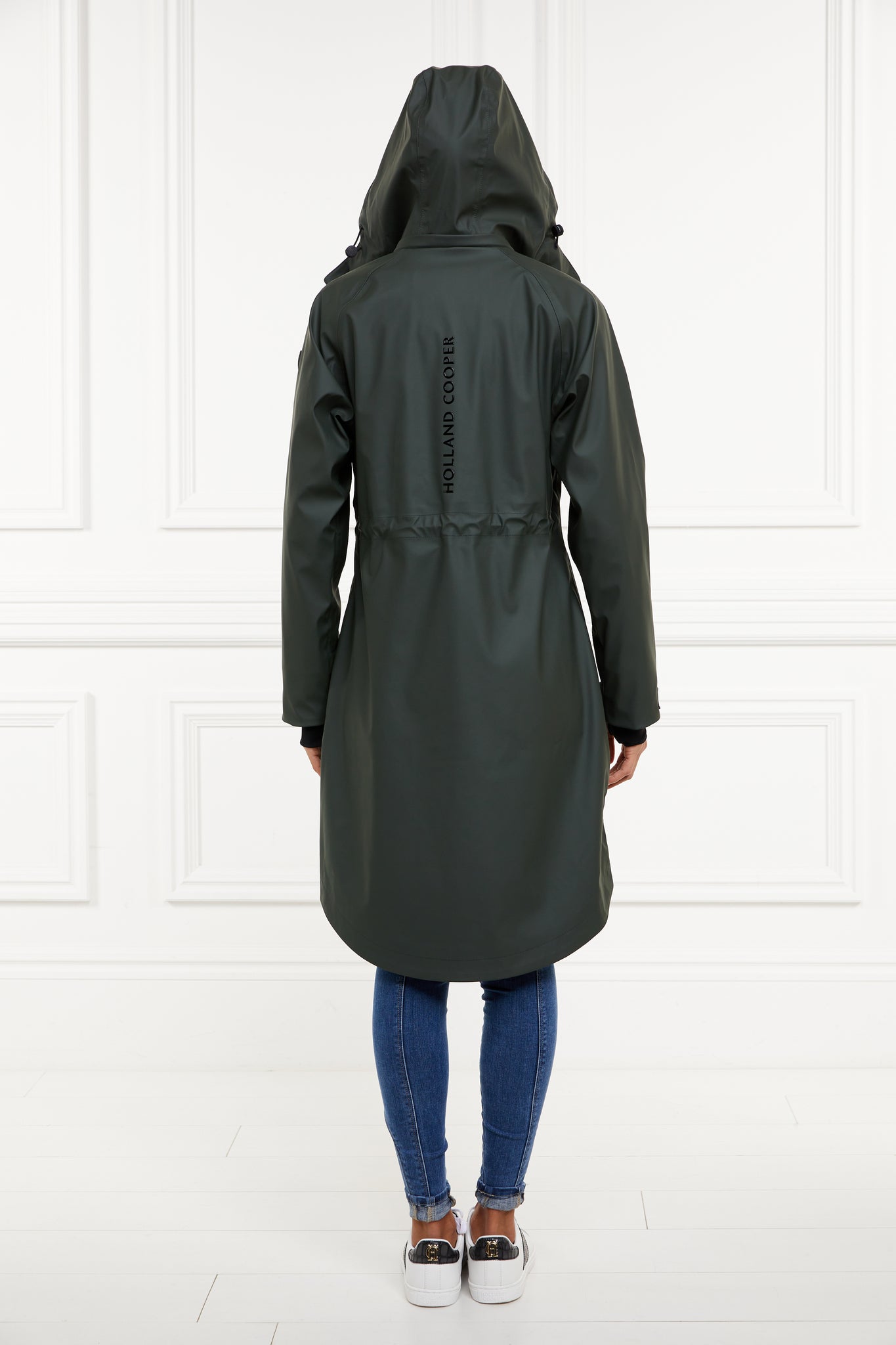 back of womens green hooded rain coat with black hardware 