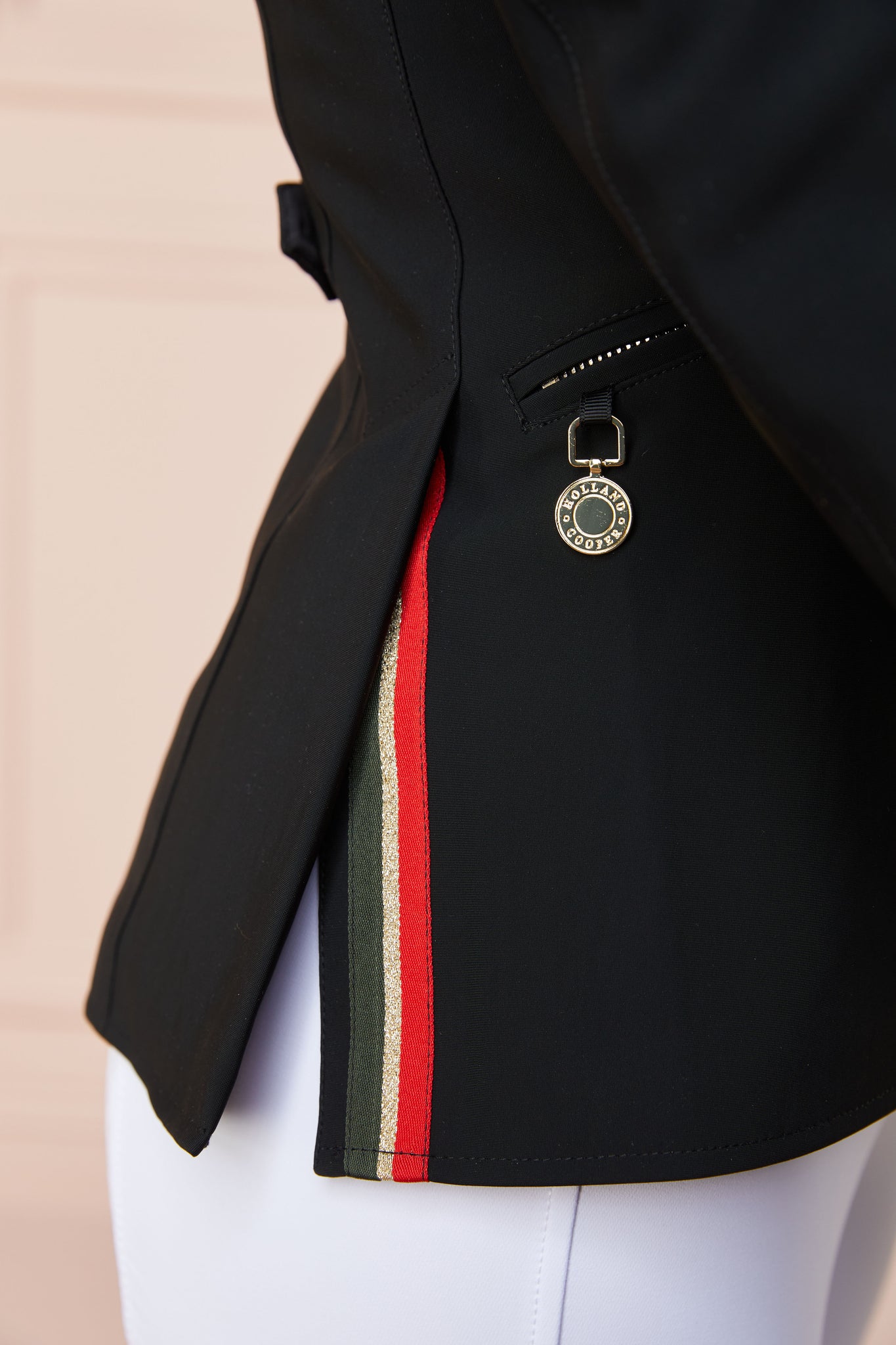 detail of womens black competition jacket with gold hardware 