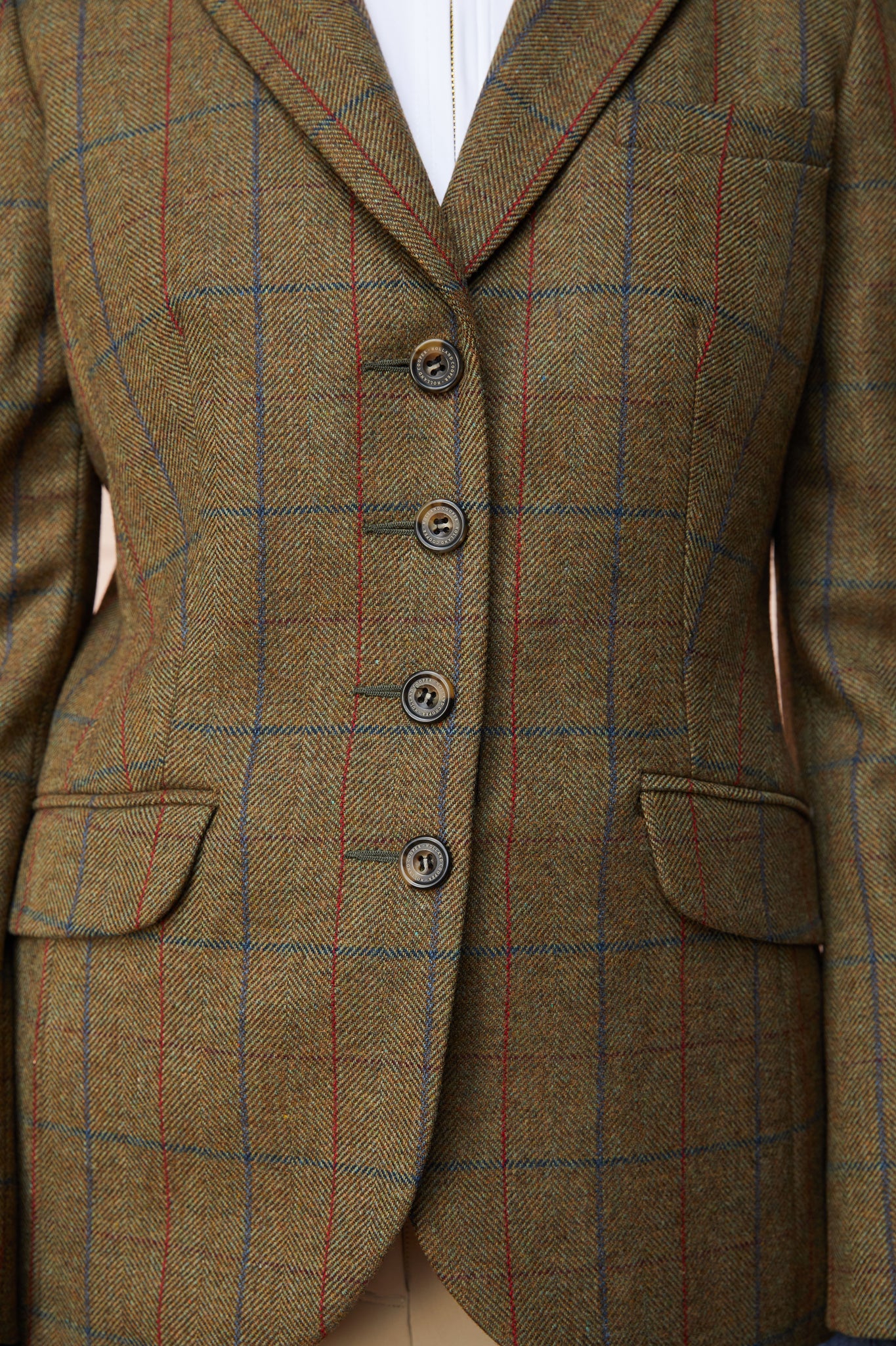 front detail of womens green tweed riding jacket with velvet collar