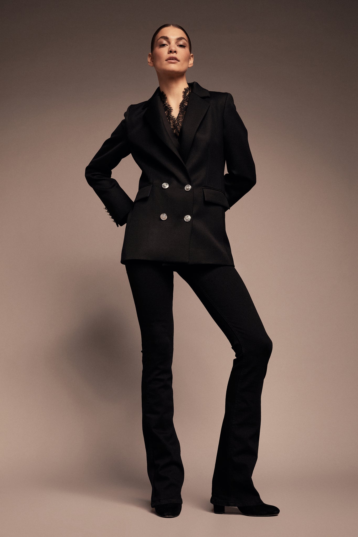 jubilee edition of double breasted wool blazer in black with two hip pockets and silver button details down front and on cuffs and handmade in the uk worn with black flared jeans and black ankle boots