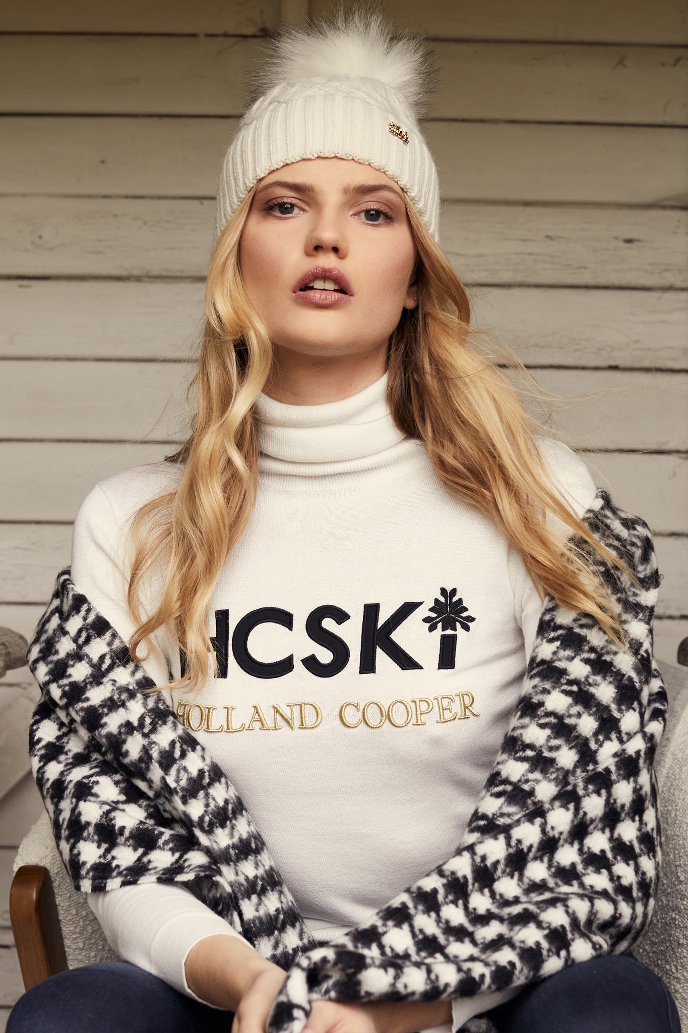 thermal fitted roll neck jumper in white with black and gold HC Ski branding in a high build embroidery across front