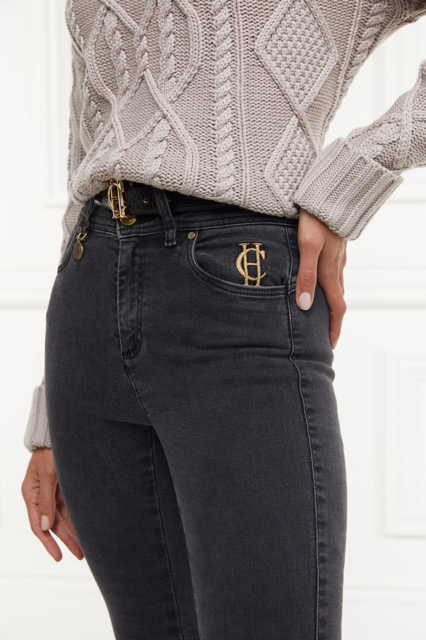 front pocket detail on womens high rise washed black denim skinny stretch jean with jodhpur style seam and two open pockets to the front with hc embroidery on front left pocket