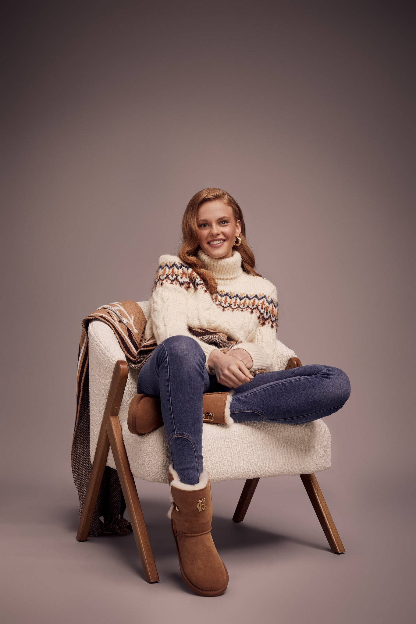 high roll neck cable knit jumper in cream with a blue orange and yellow fairisle knit detail across the chest around the upper arm and back