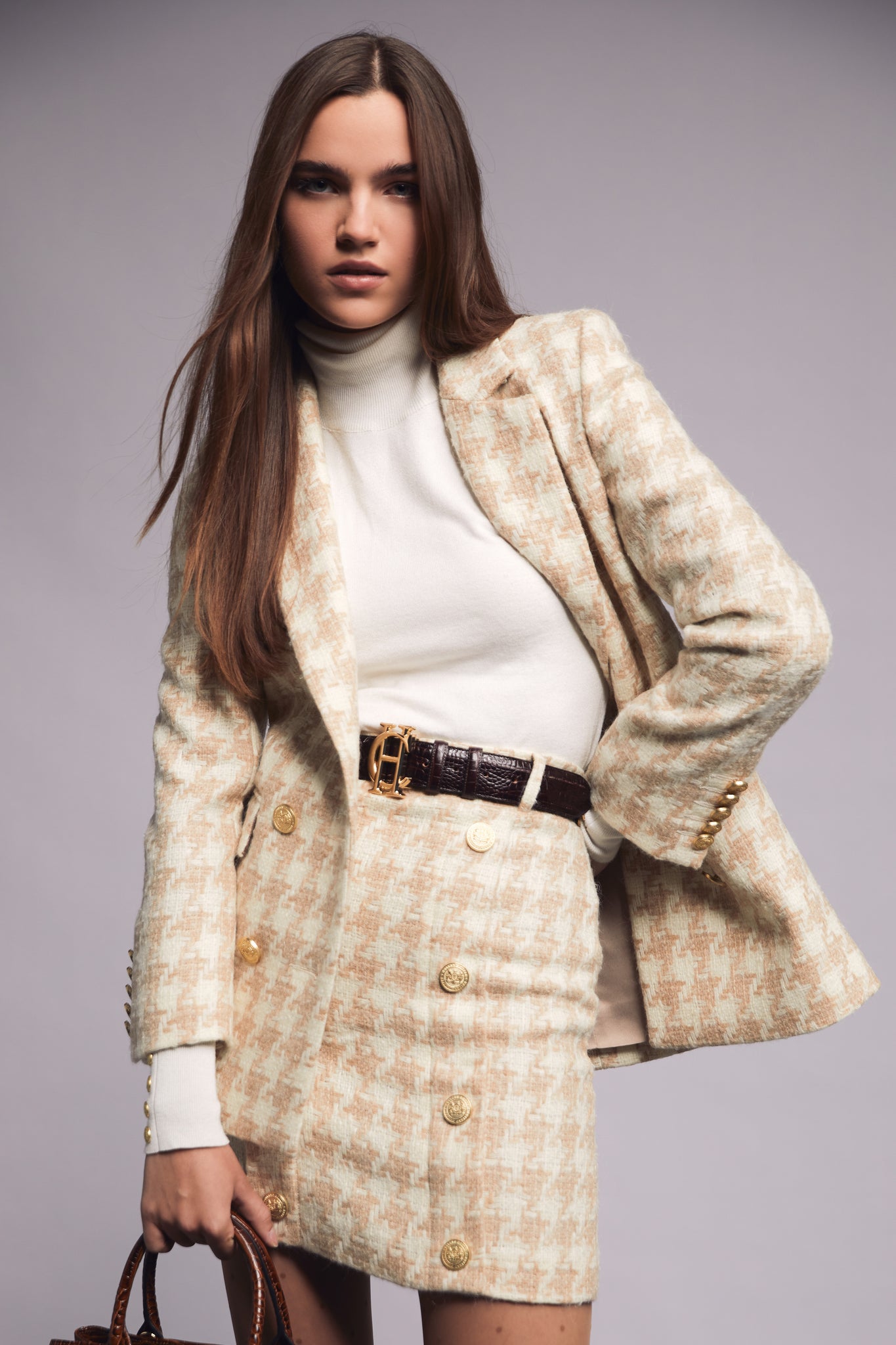 womens cream and camel houndstooth wool pencil mini skirt with concealed zip fastening on centre back and gold rivets down front worn with double breasted blazer in matching colourway
