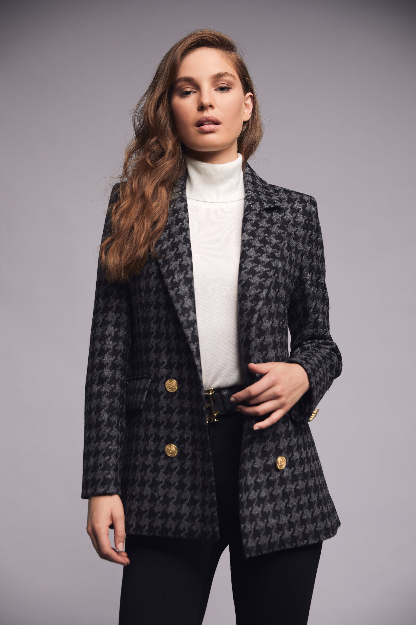 double breasted wool blazer in grey and black large scale houndstooth with two hip pockets and gold button details down front and on cuffs and handmade in the uk