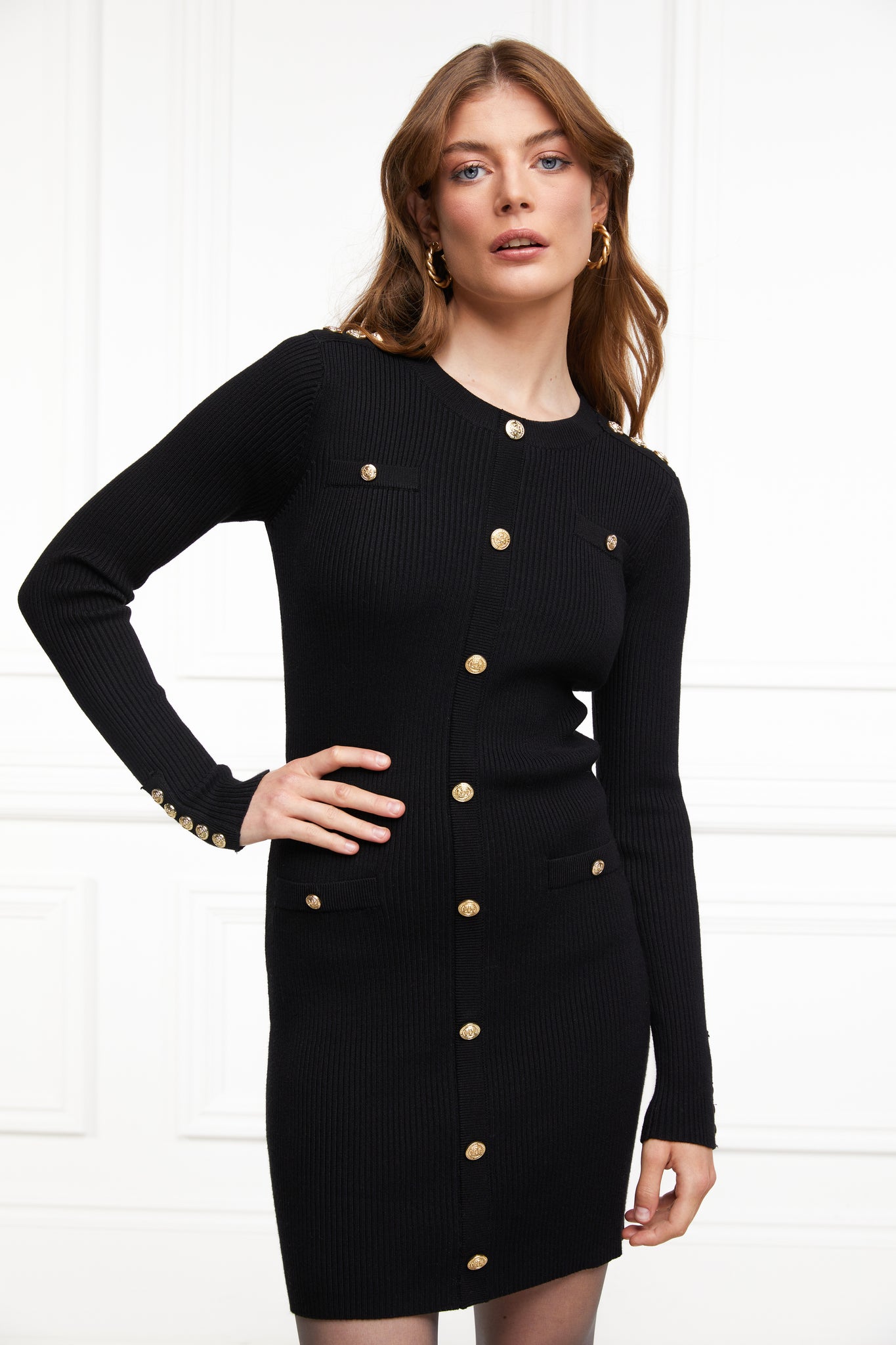 womens slim fit crew neck long sleeve knitted dress in black with gold button detail down the centre front and two welt pockets on chest and two on the hips with gold buttons on the centre of each pocket