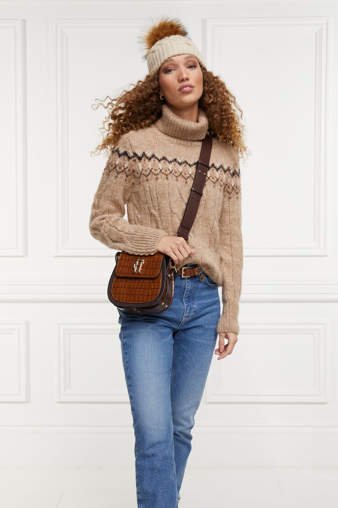 high roll neck cable knit jumper in camel with a black cream and dark camel fairisle knit detail across the chest around the upper arm and back
