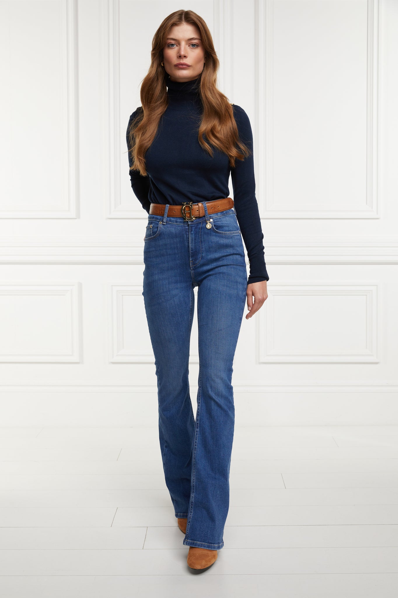 womens high rise blue denim flared jean with centre front zip fly fastening with two open pockets at the front and back and gold hardware on back waistband