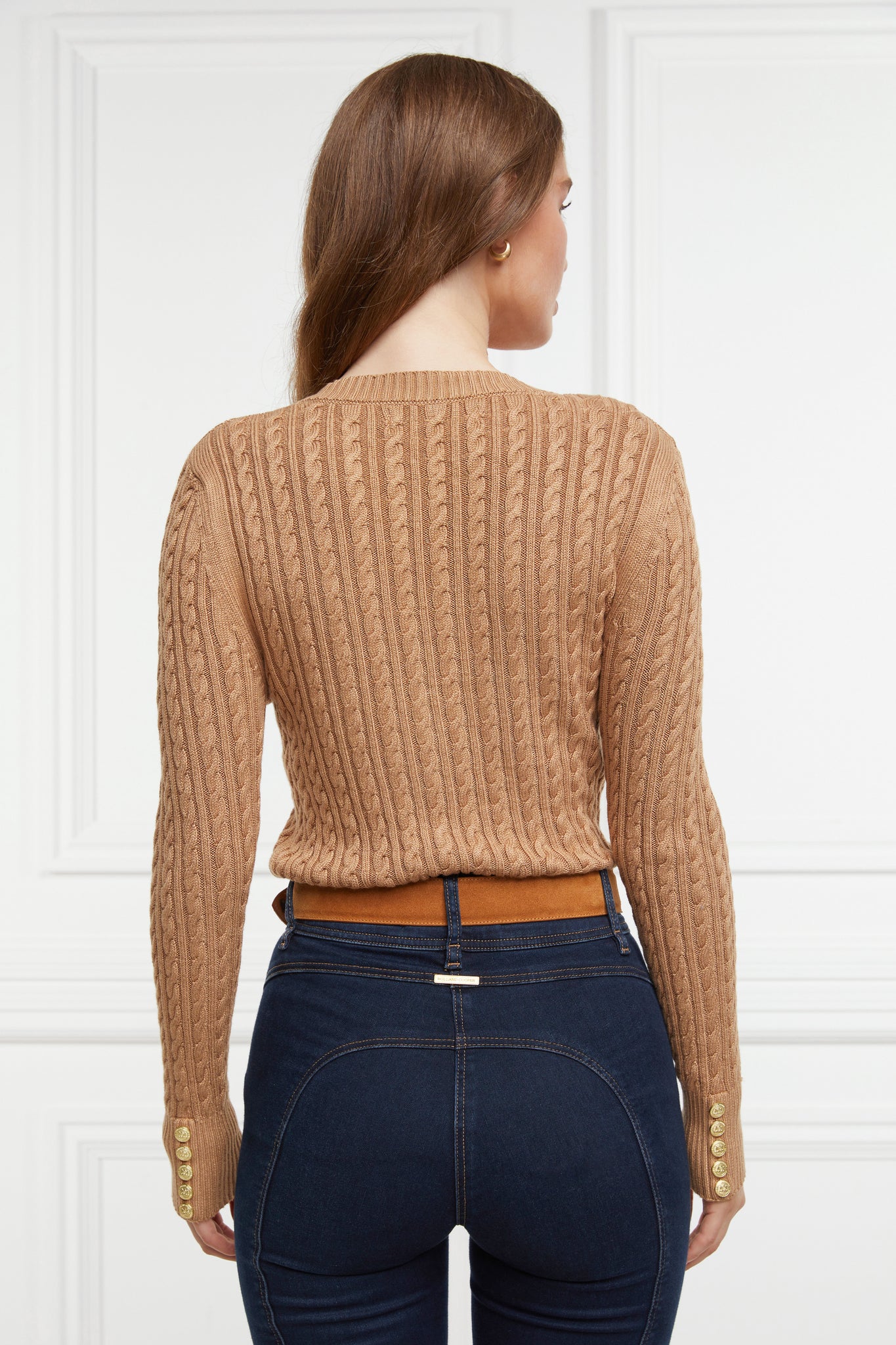 back of womens lightweight v neck cable knit jumper in dark caramel detailed with gold buttons at the cuffs