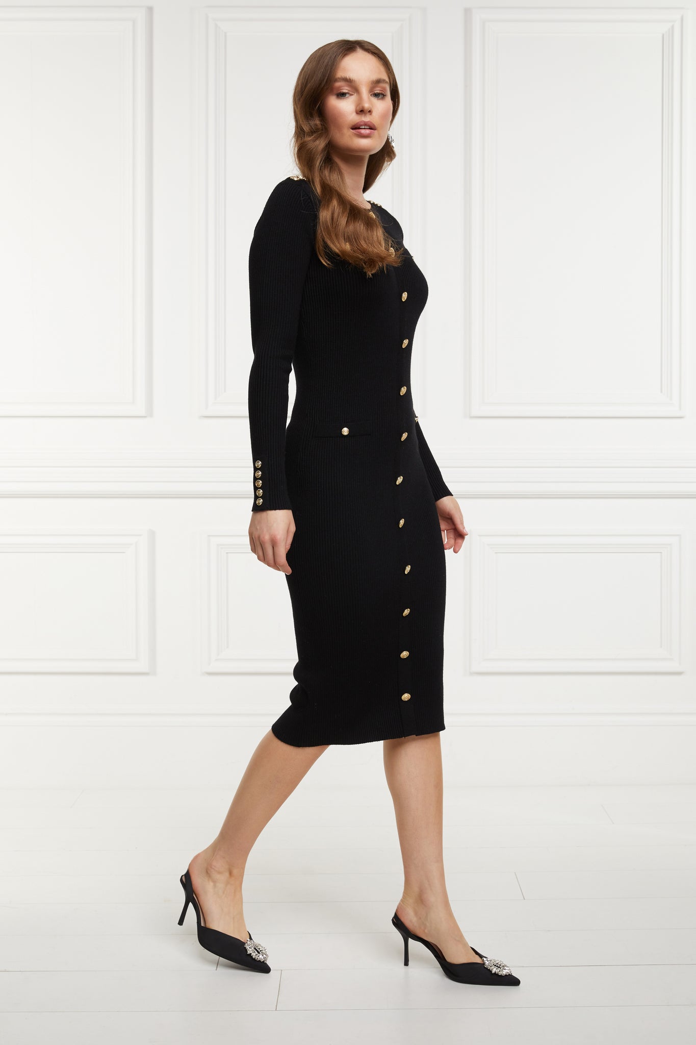 womens slim fit crew neck long sleeve knitted midi dress in black with gold button detail down the centre front and two welt pockets on chest and two on the hips with gold buttons on the centre of each pocket