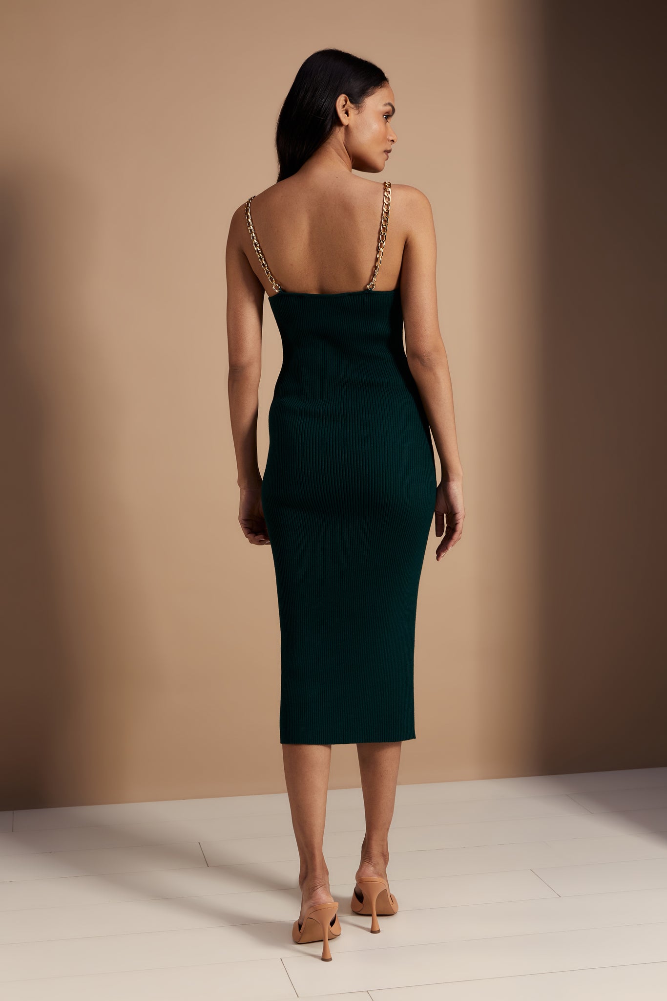 back shot of womens emerald ribbed v neck midi dress with gold chain strap